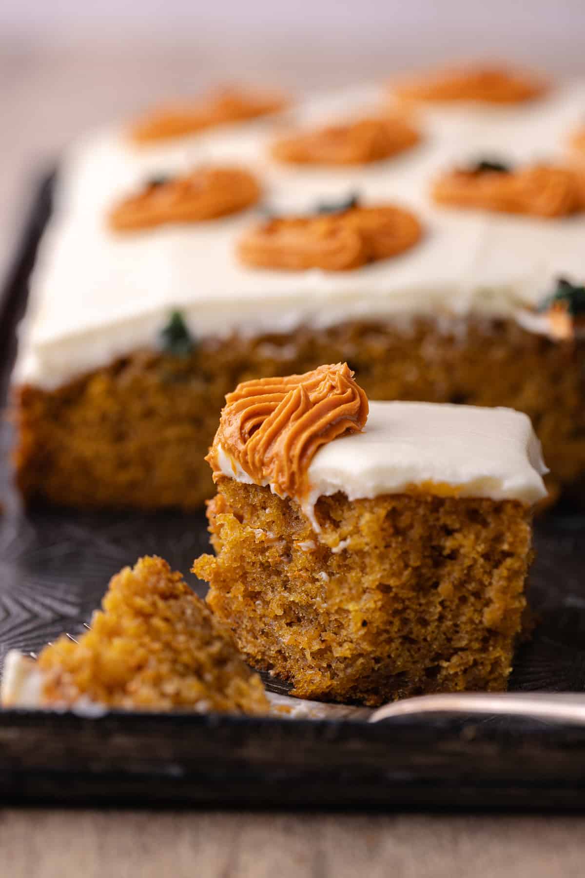 A close up of a slice of Pumpkin Chai Cake on a baking sheet.