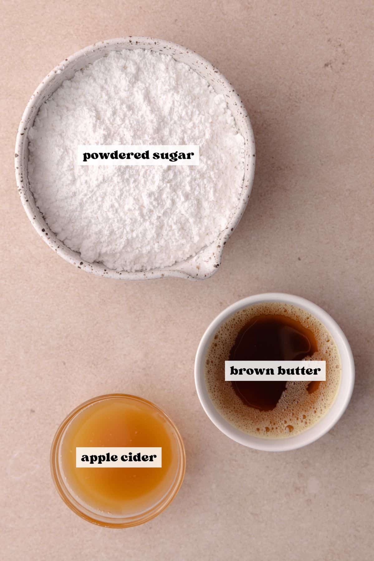 Ingredients for the brown butter apple cider glaze which includes, brown butter, apple cider and powdered sugar.