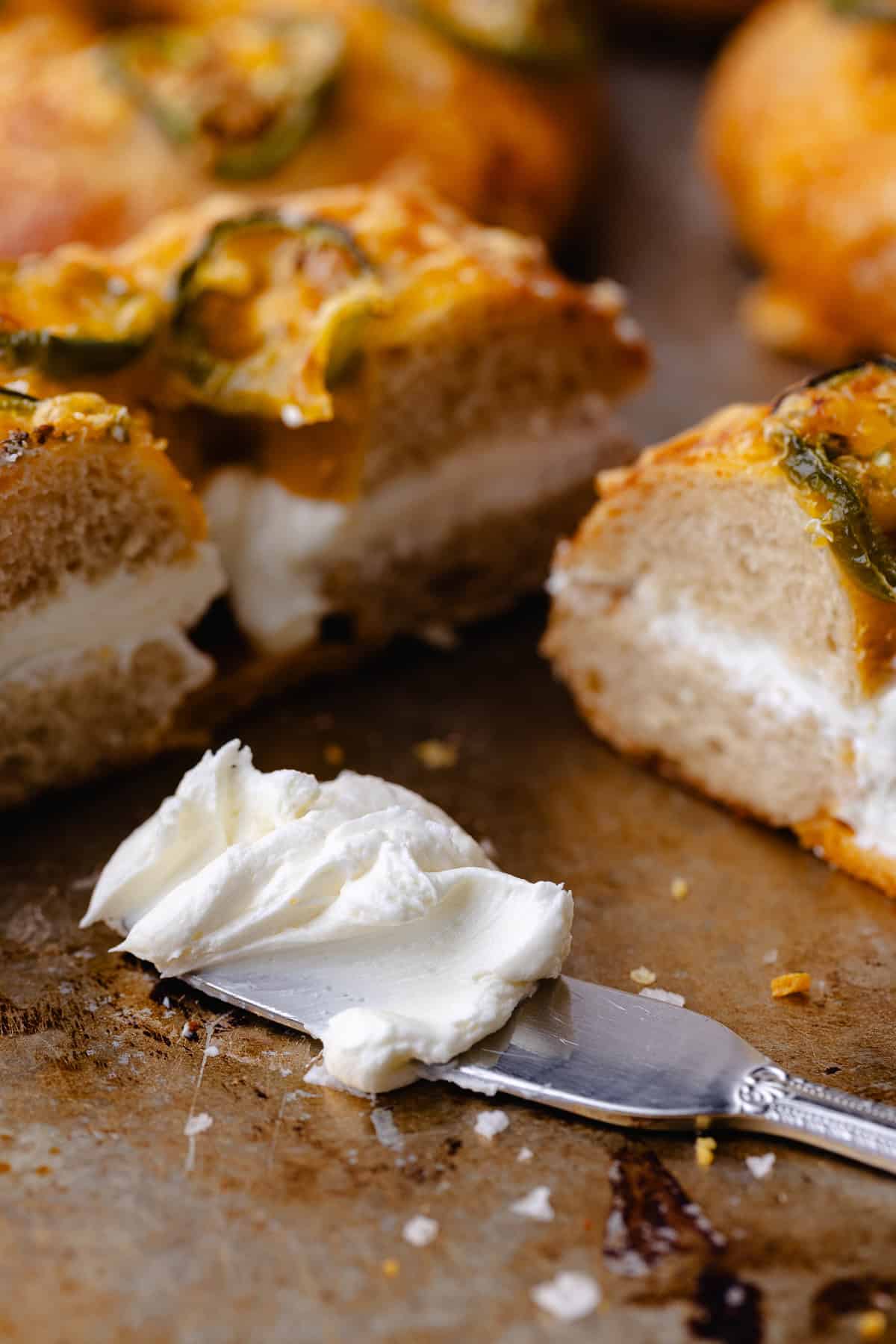 Whipped cream cheese, bagel schmear on a spread knife.