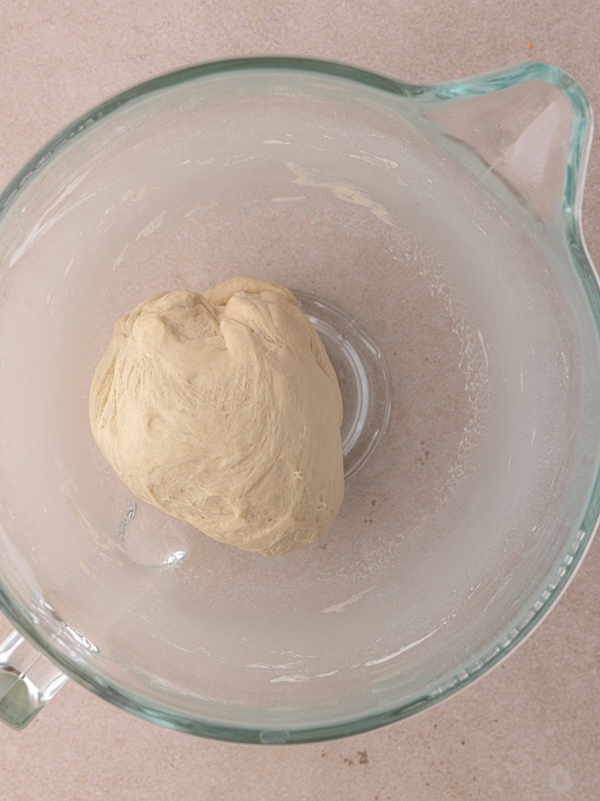 The bagel dough is kneaded in the stand mixer bowl.