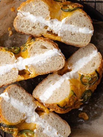 Jalapeño cheddar bagels filled with cream cheese schmear on a plate featured photo.