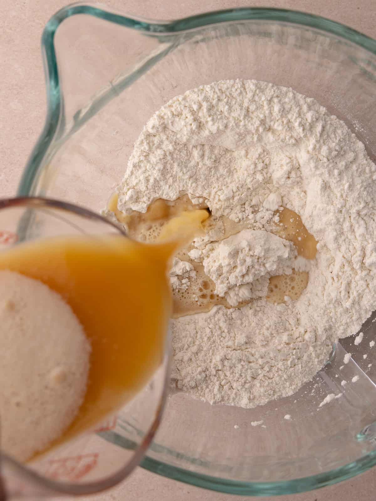 Frothy yeast mixture is poured into the flour mixture.