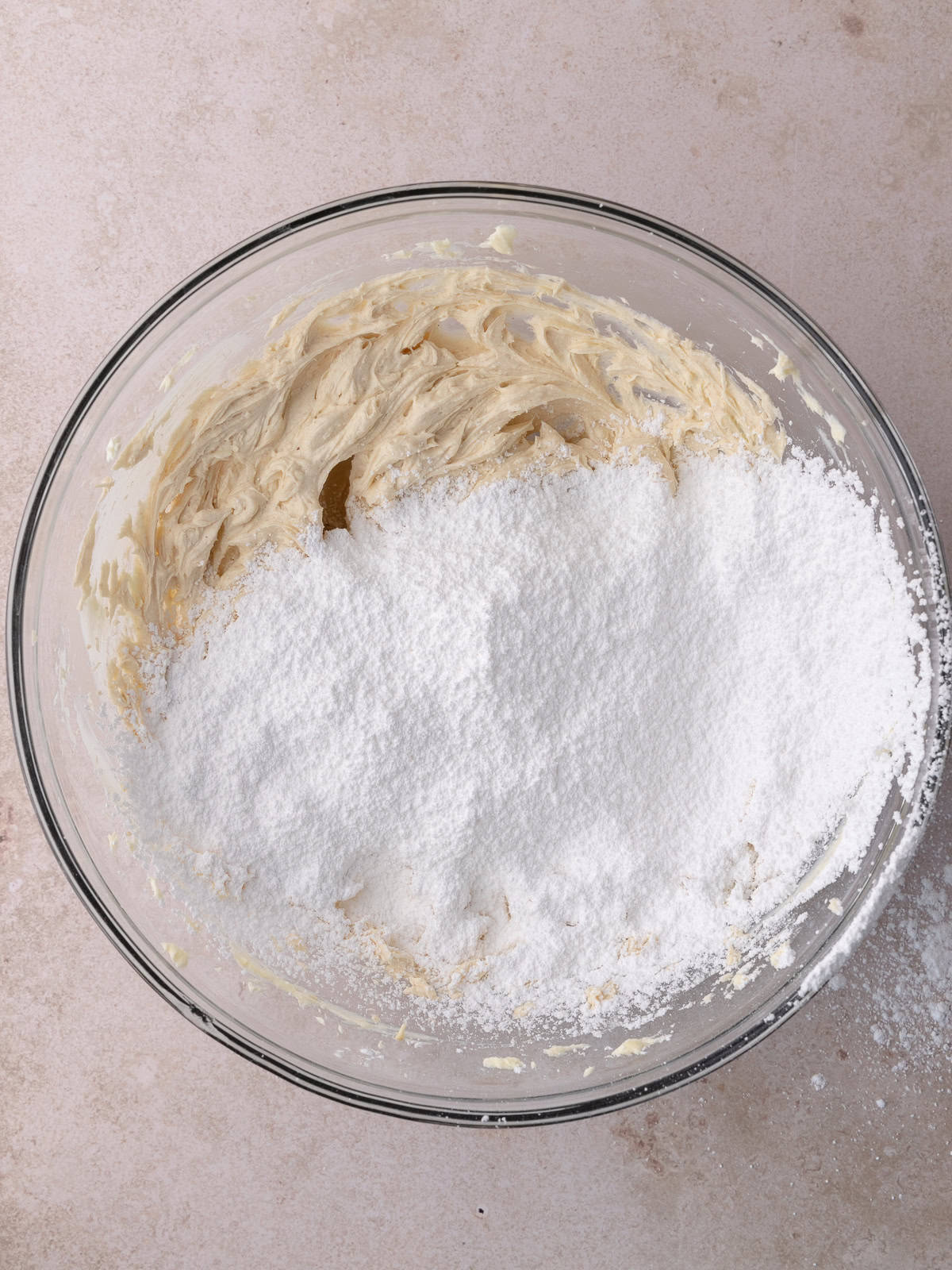 Sifted powdered sugar is added to the butter/cream cheese mixture.