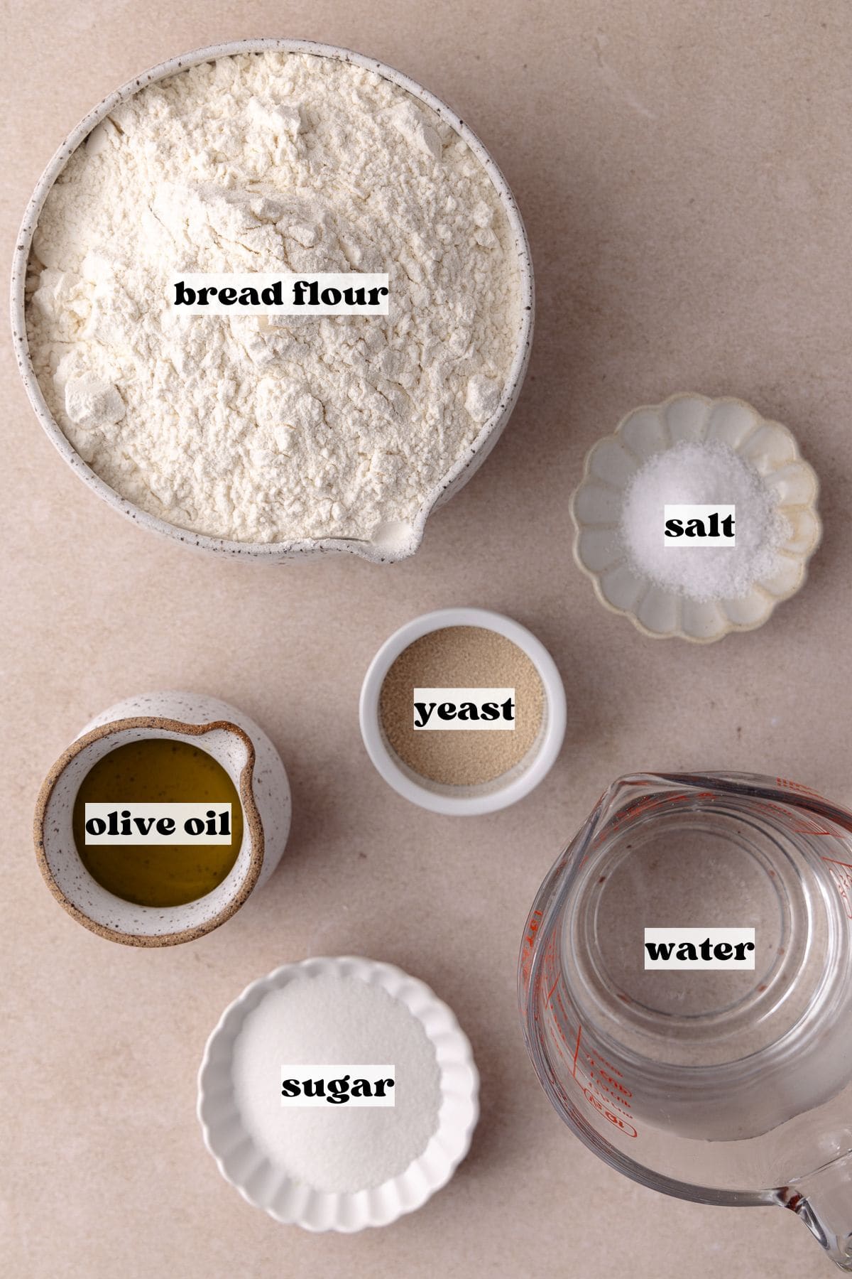 Overnight focaccia dough ingredients which include, bread flour, yeast. sugar, olive oil, water and salt.