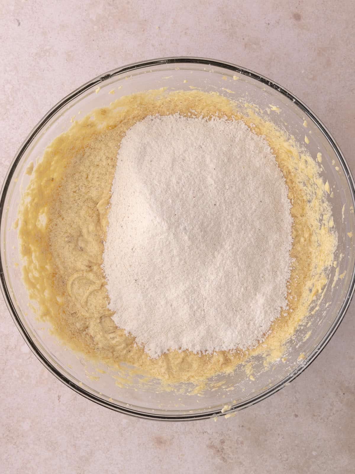 Dry ingredients are sifted into the batter.