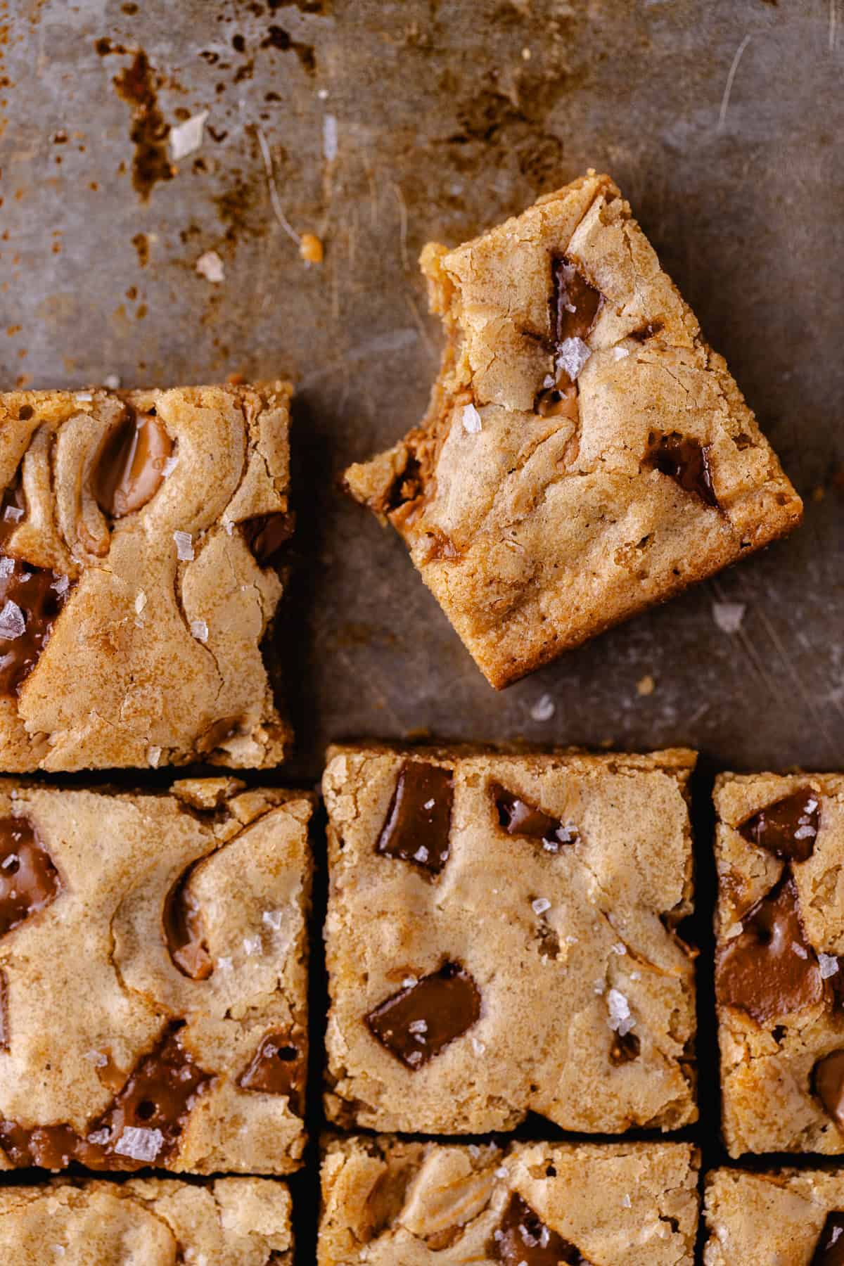 Toffee Cookie Butter Blondies cut into squares and sitting on a cookie sheet.