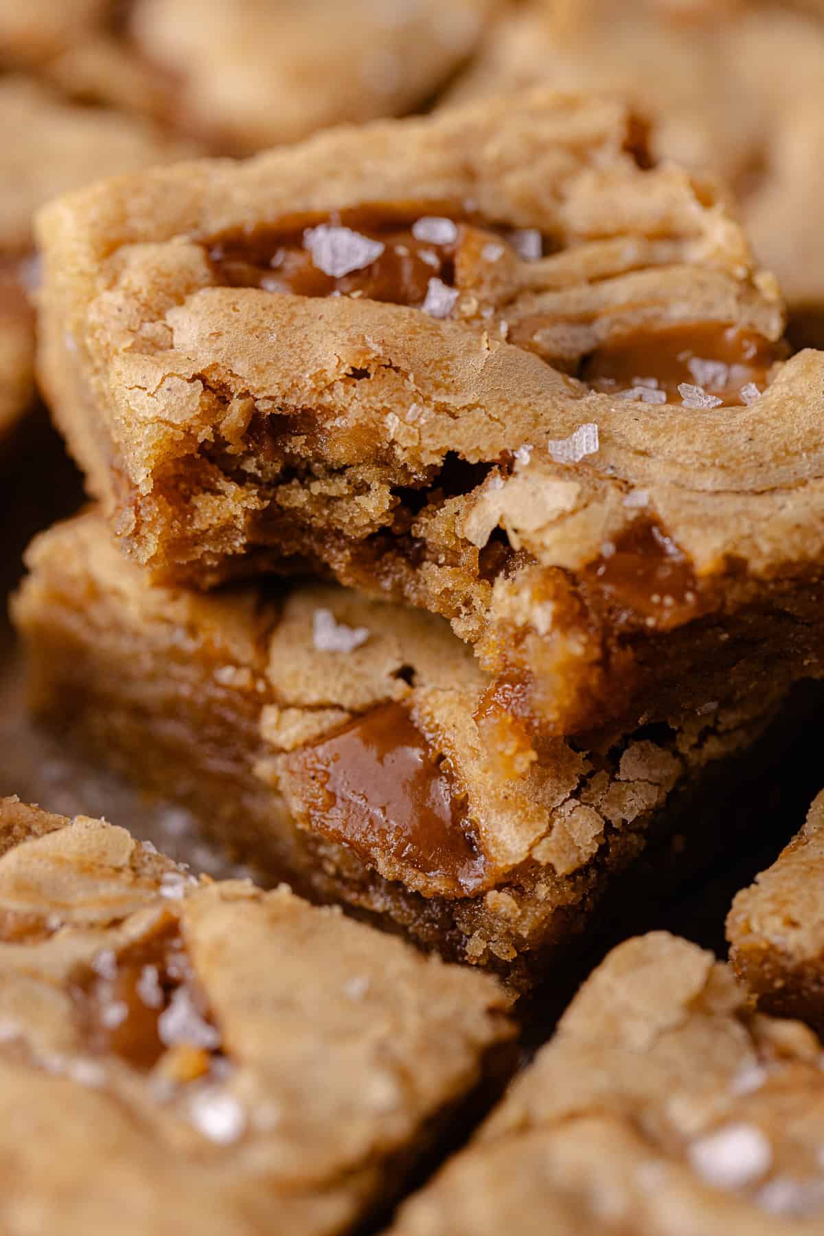 Cookie Butter Blondies squares stacked on a cookie sheet.