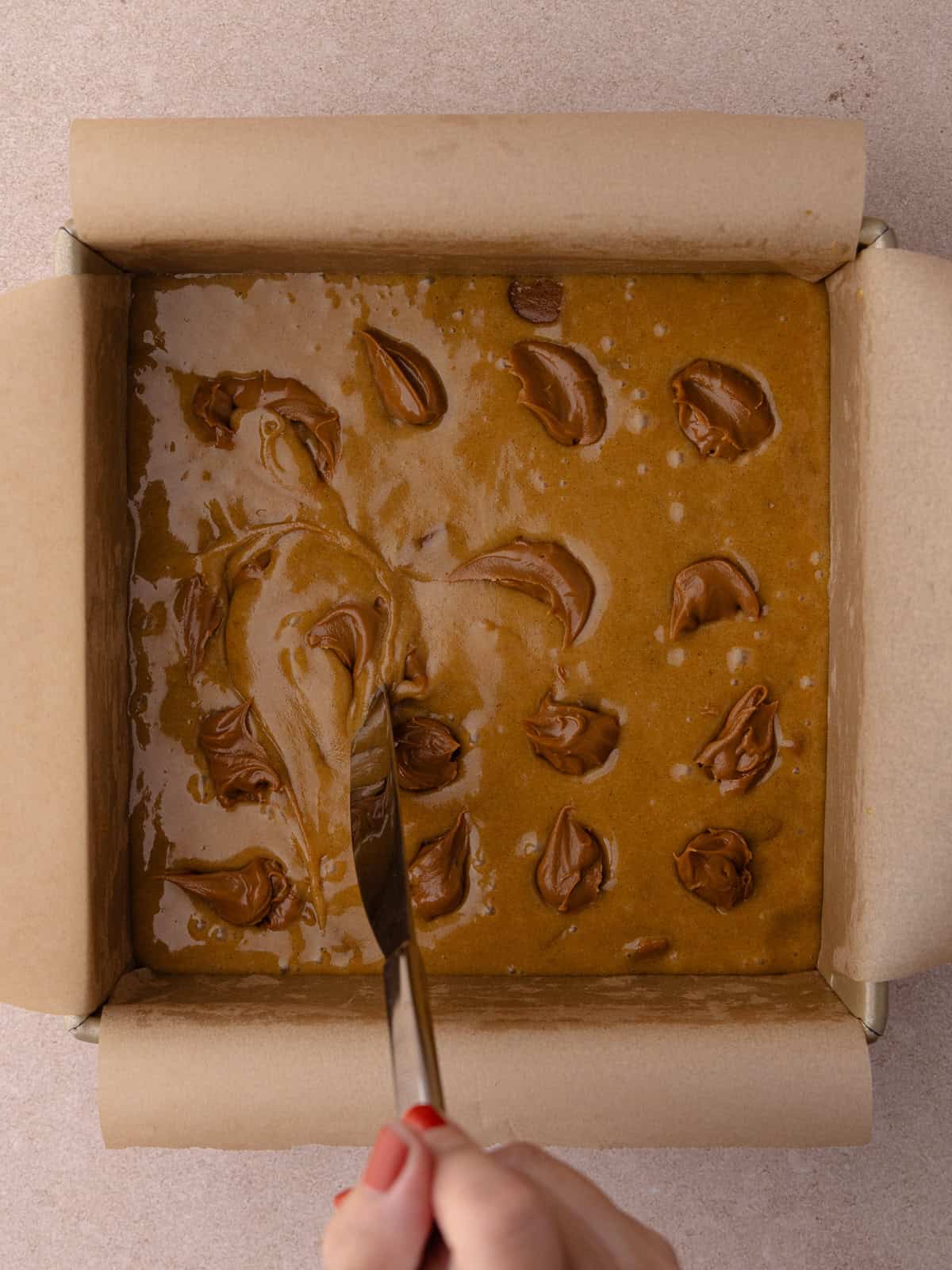 Dollops of cookie butter are swirled into the blondie batter.