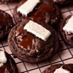 Chocolate cookies and cream cookies sitting on a wire rack featured photo.