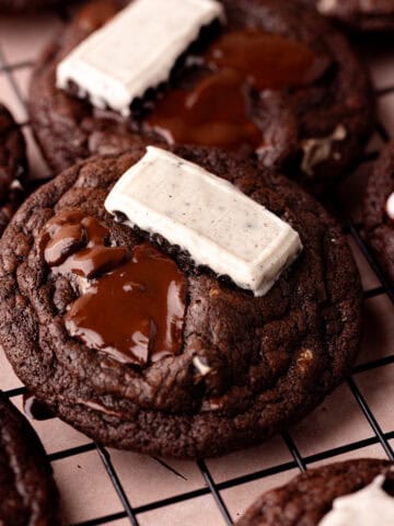 Chocolate cookies and cream cookies sitting on a wire rack featured photo.