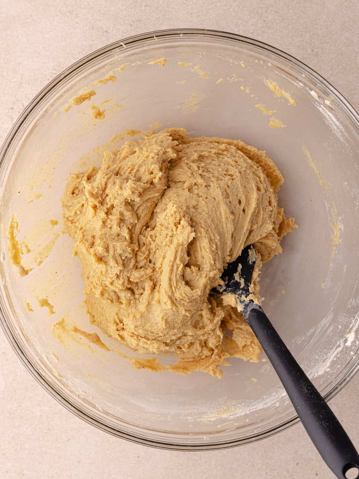 Cinnamon toast crunch cookie dough is mixed together are is sitting in a mixing bowl.