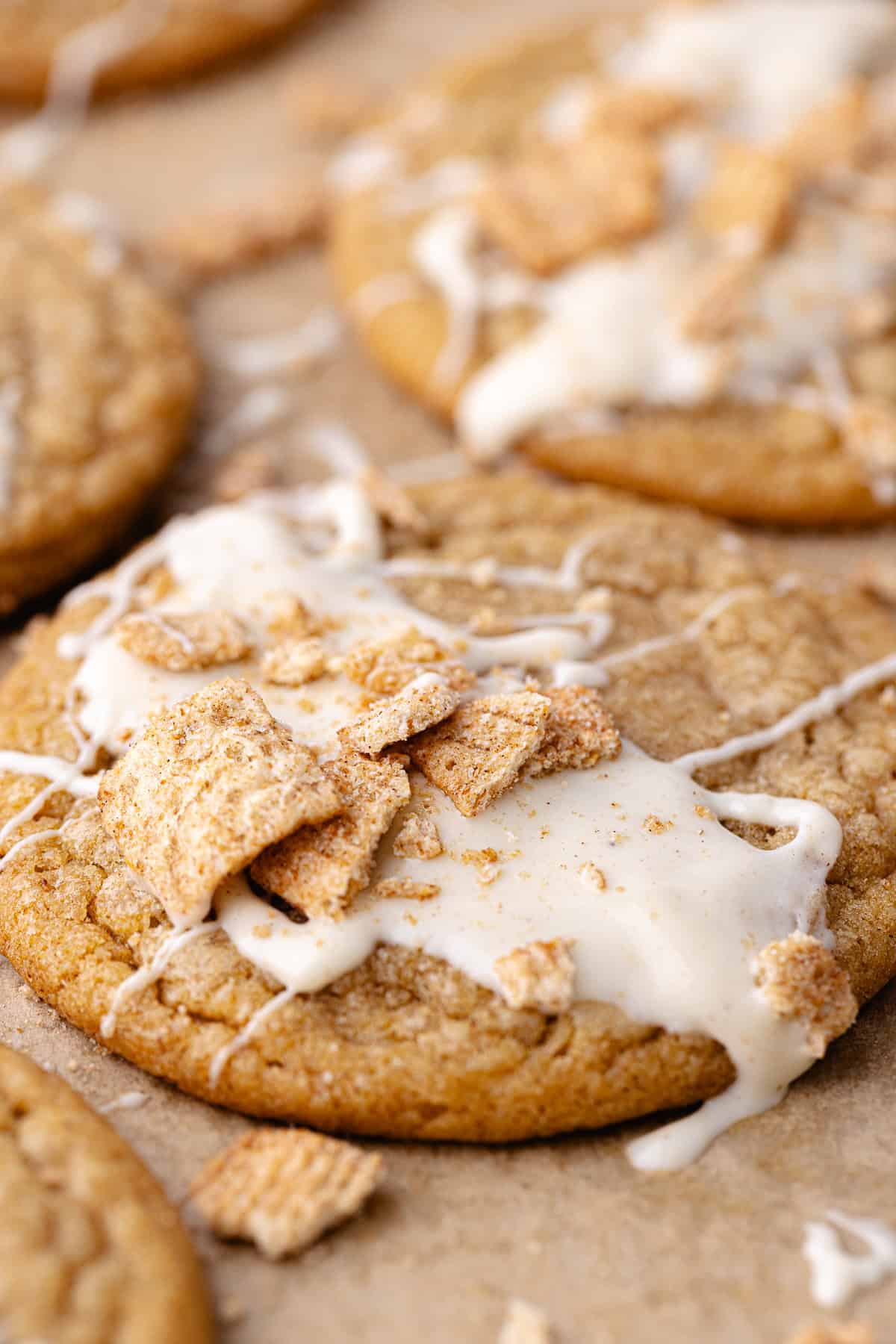 Soft and chewy cinnamon toast crunch cookies drizzled with white chocolate and crushed cinnamon toast crunch cereal.