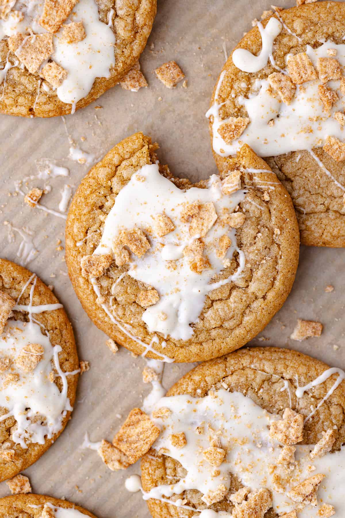 Soft and chewy cinnamon toast crunch cookies drizzled with white chocolate and crushed cinnamon toast crunch cereal.