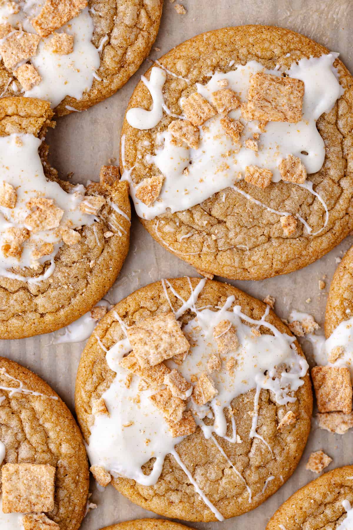 Soft and chewy cinnamon toast crunch cookies drizzled with white chocolate and crushed cinnamon toast crunch cereal.