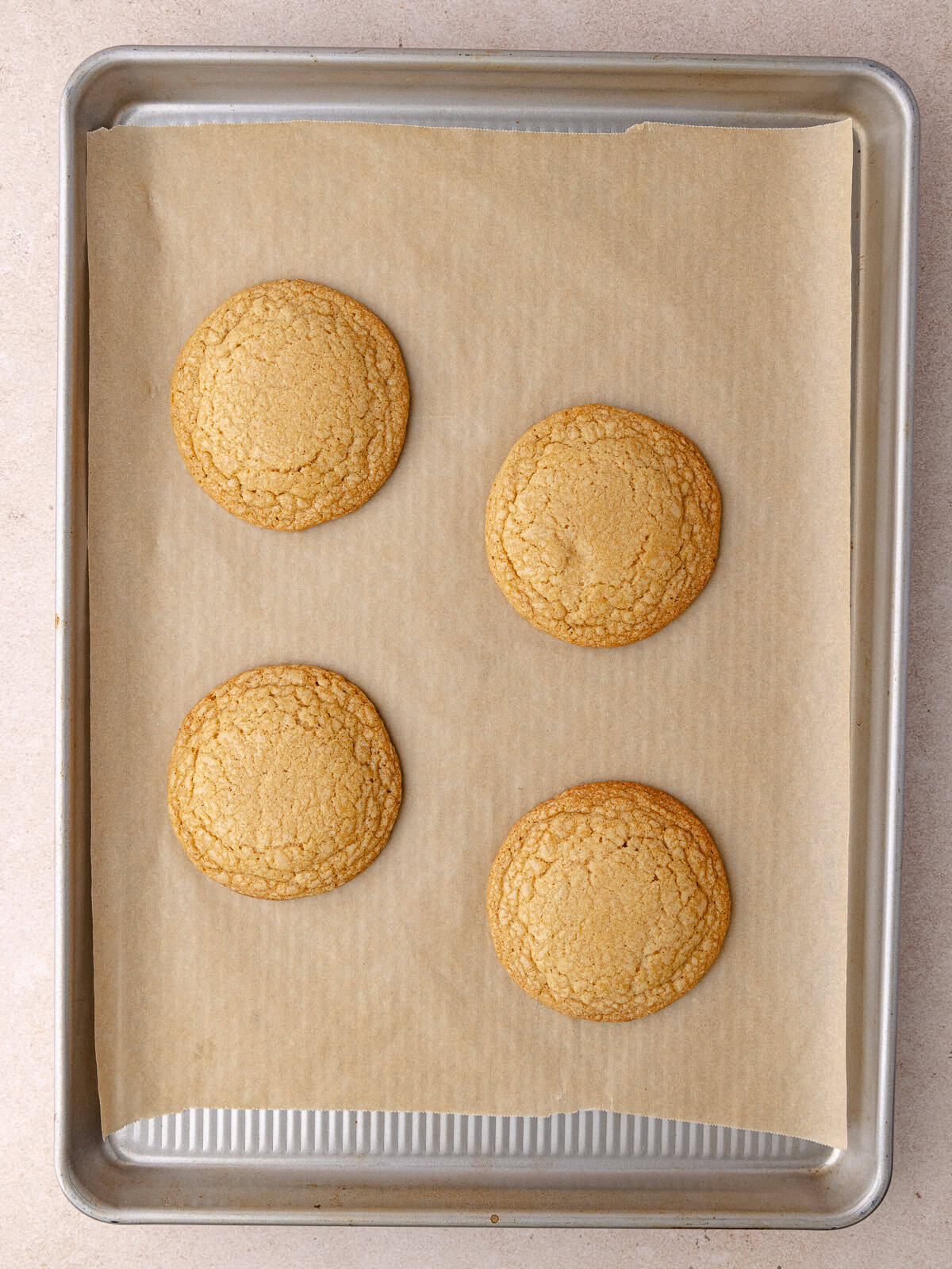 Cinnamon toast crunch cookies are bake until golden brown and are sitting on a baking sheet.