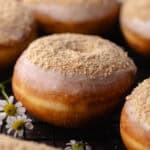 Glazed cinnamon toast crunch donuts sitting on a wire rack featured photo.