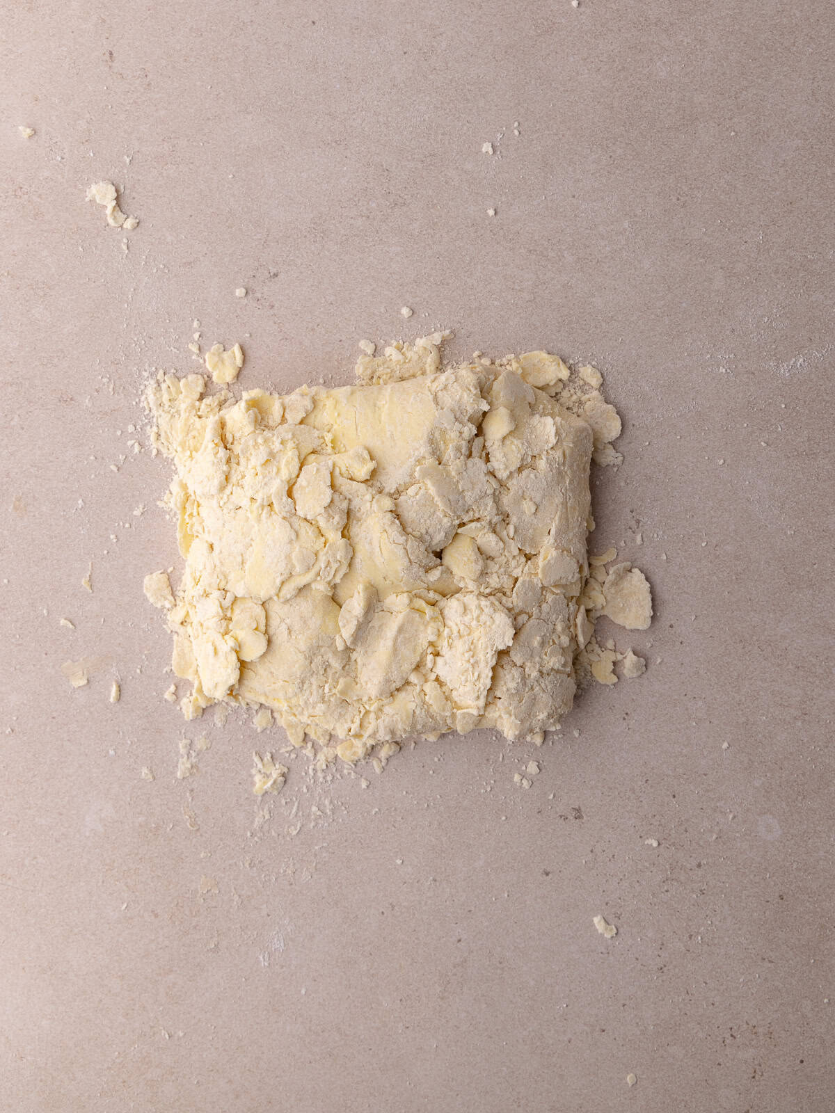 The flattened dough is folded onto itself into a rectangle.