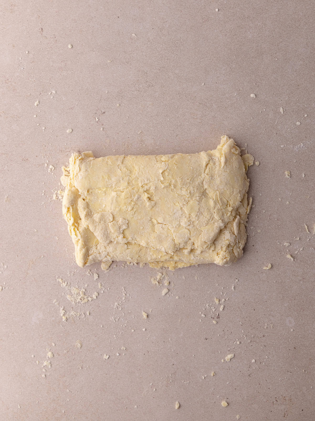 The pie dough is folded into thirds.