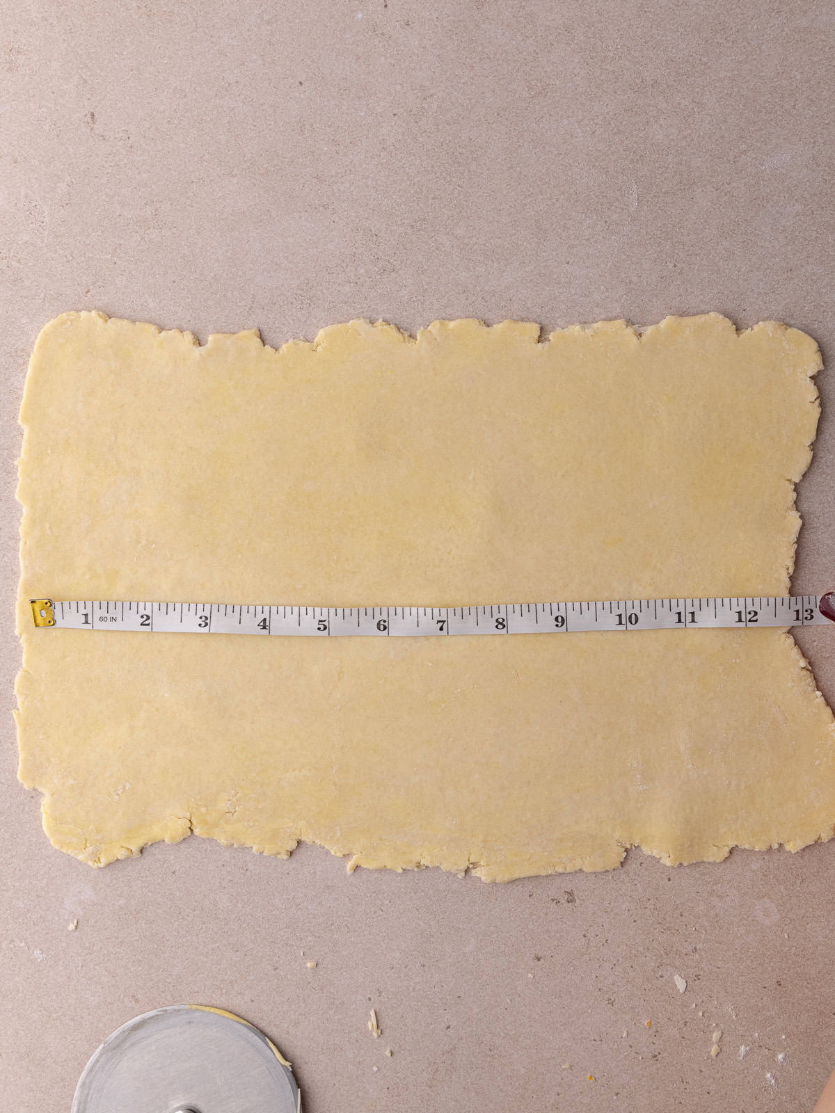 Pie dough is rolled out to 12 inches by 8 inches.