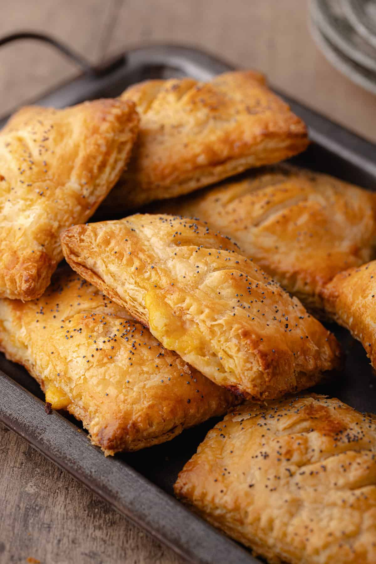 Super flaky and tender ham and cheese hand pies sitting on a serving tray.