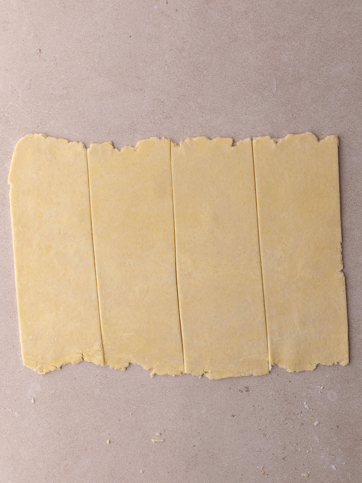 Pie dough is cut into 4 stips.