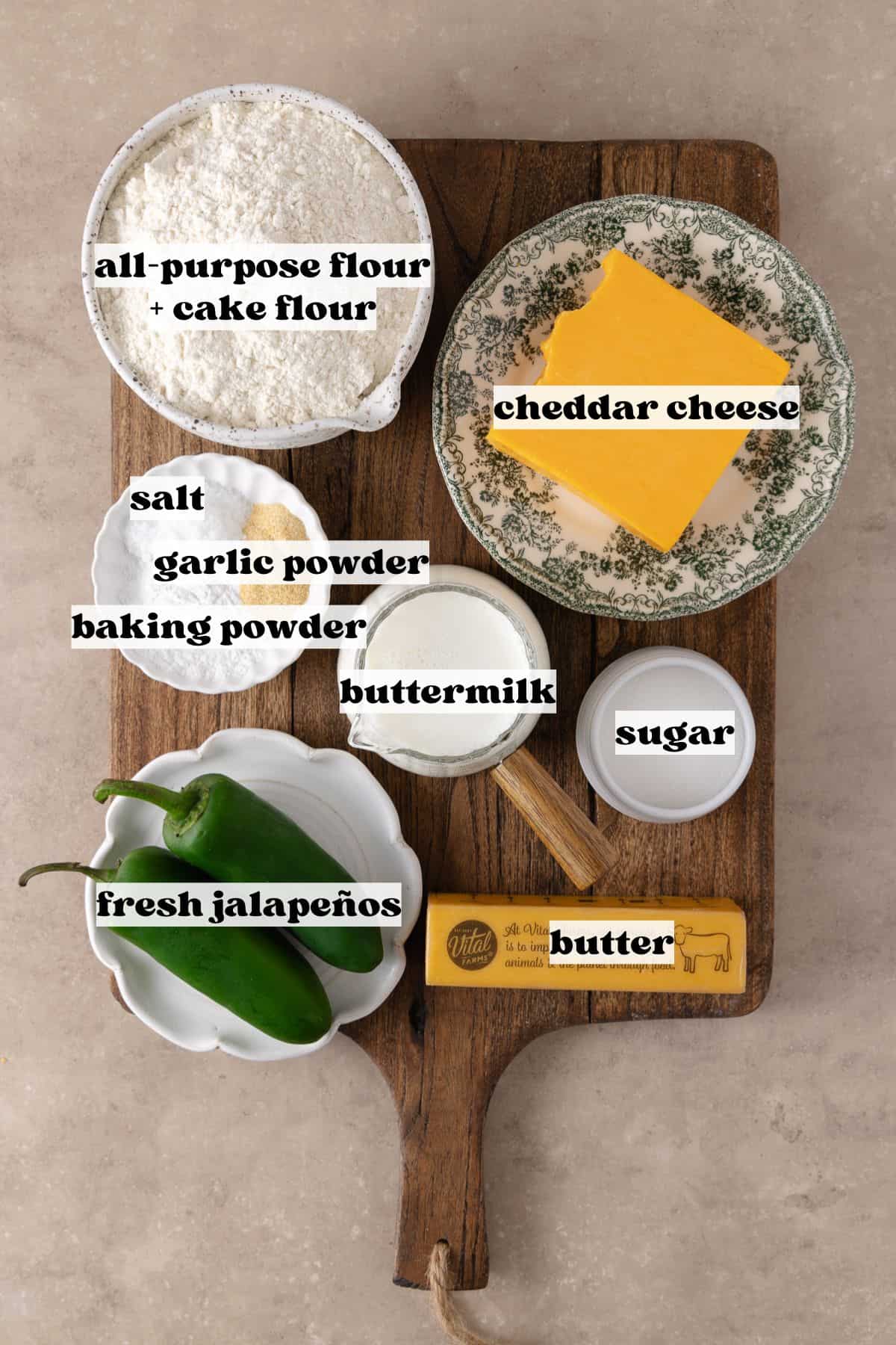 Jalapeño cheddar biscuits ingredients which include, all-purpose flour, cake flour, butter, baking powder, sugar, garlic powder, salt, cheddar cheese, jalapeños and buttermilk.