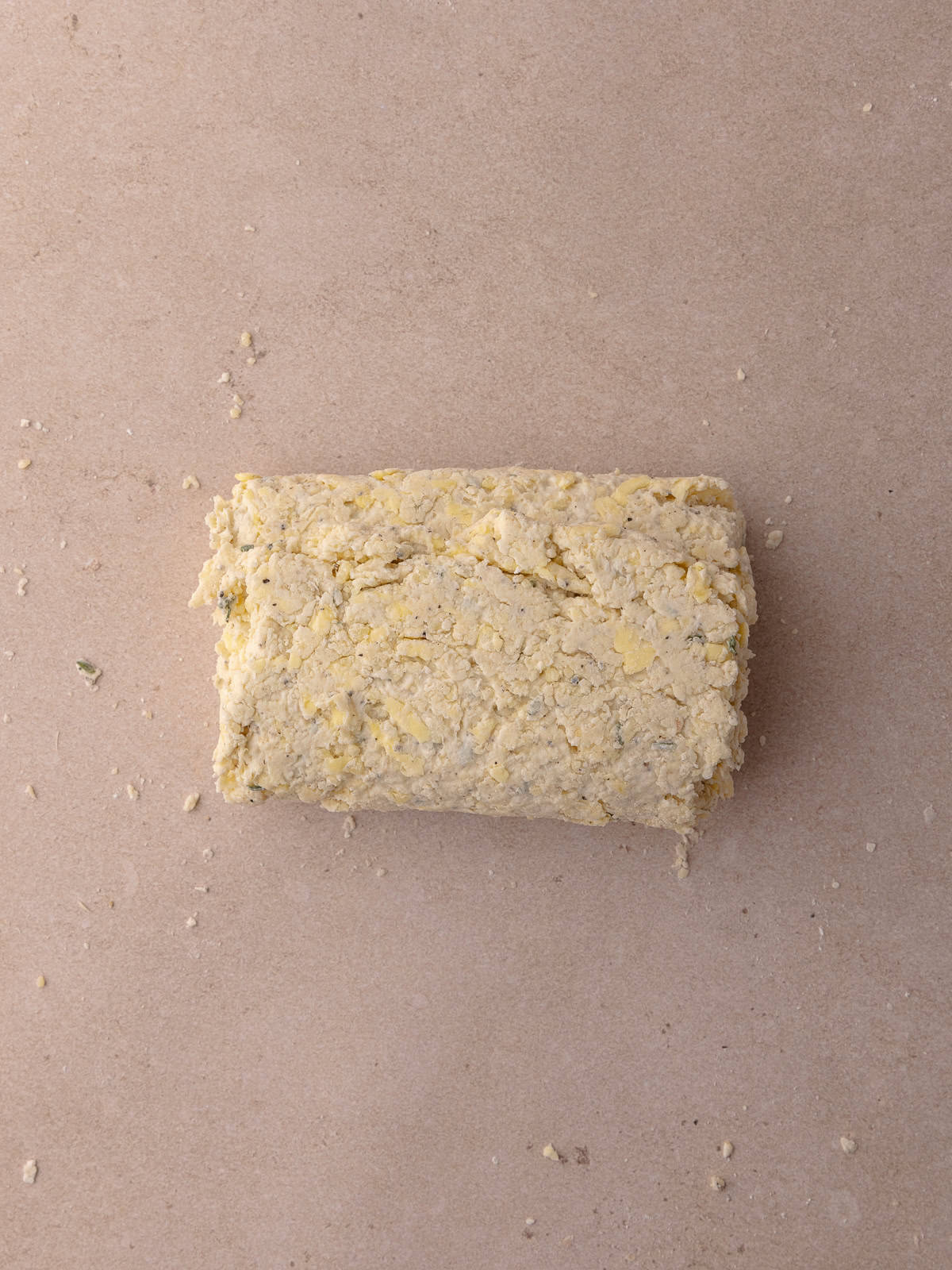 The bottom third of the thyme biscuit dough is folded over and onto itself again.