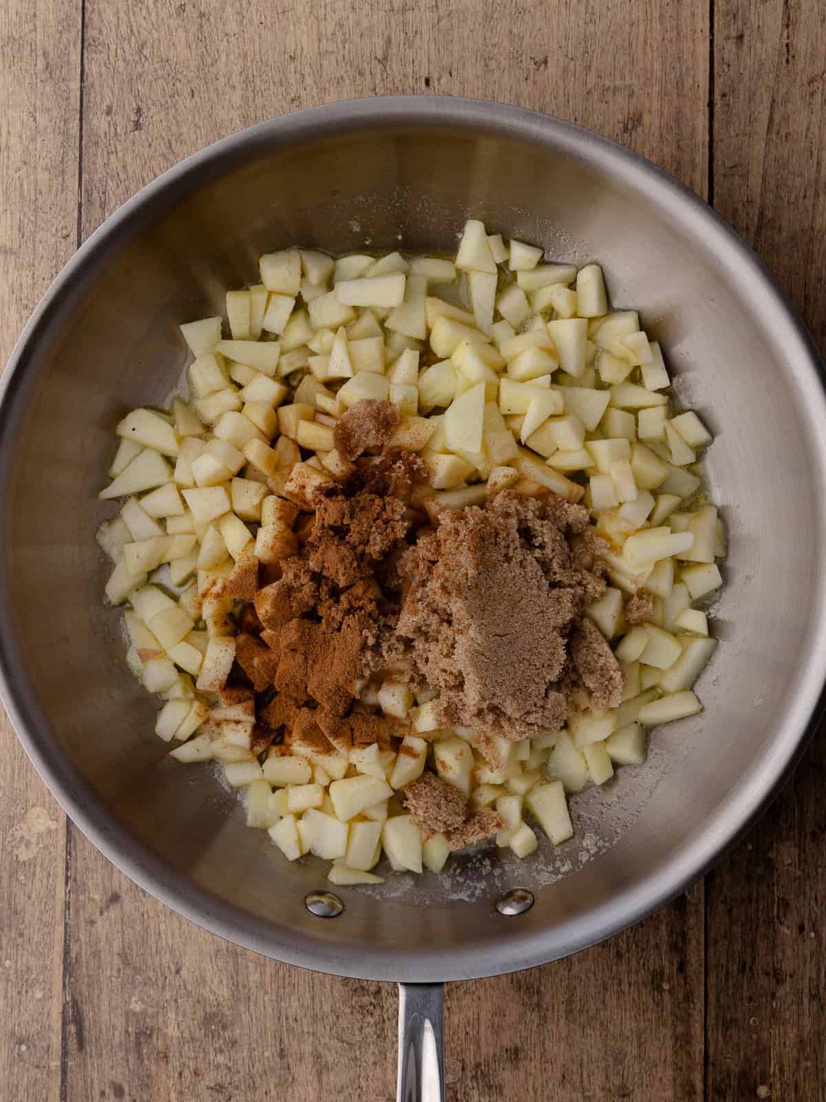 Butter, diced apples, brown sugar, cinnamon, vanilla and lemon juice are added to a pan.