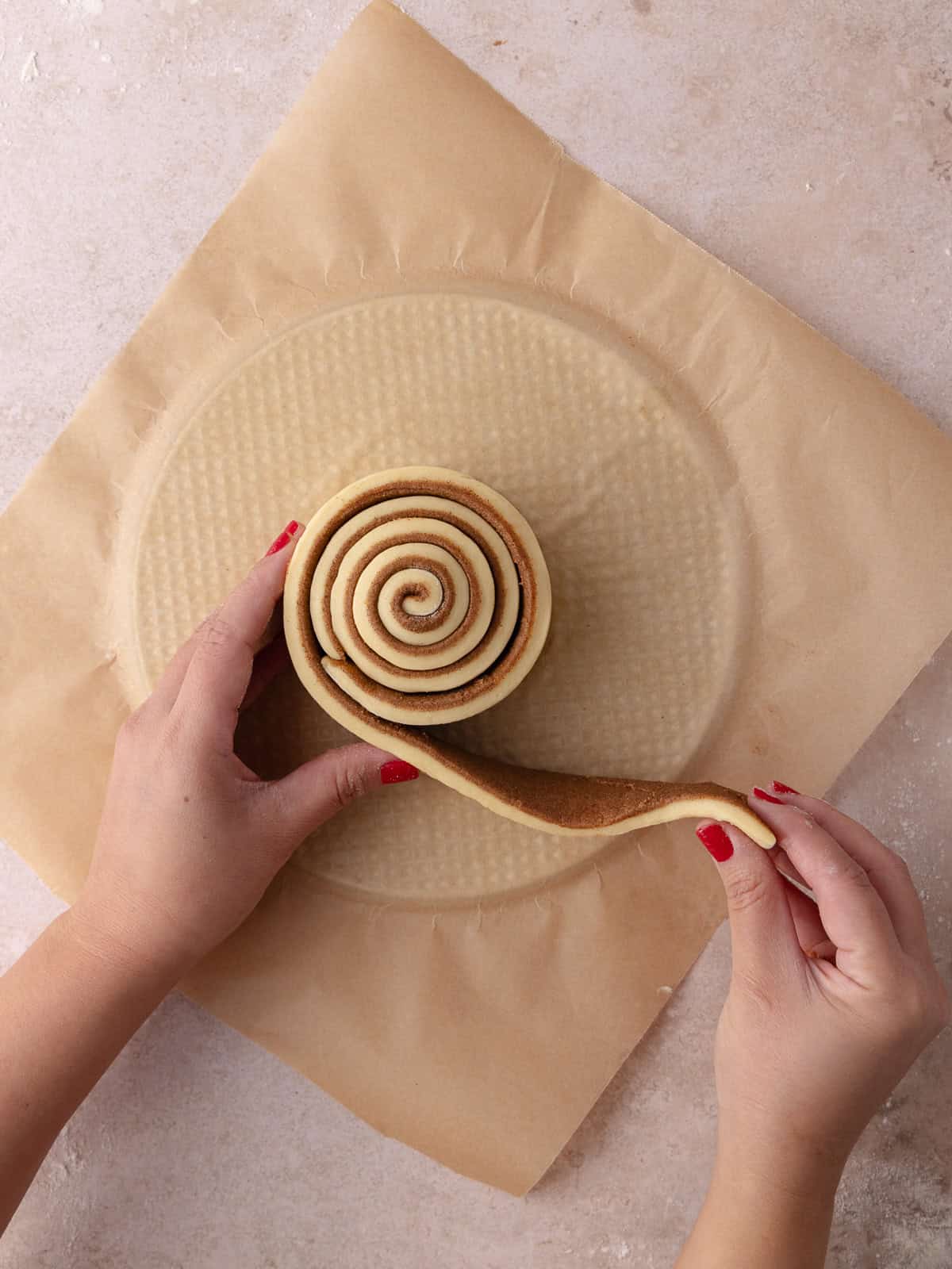 Giant cinnamon roll cake is shaped into a springform pan.