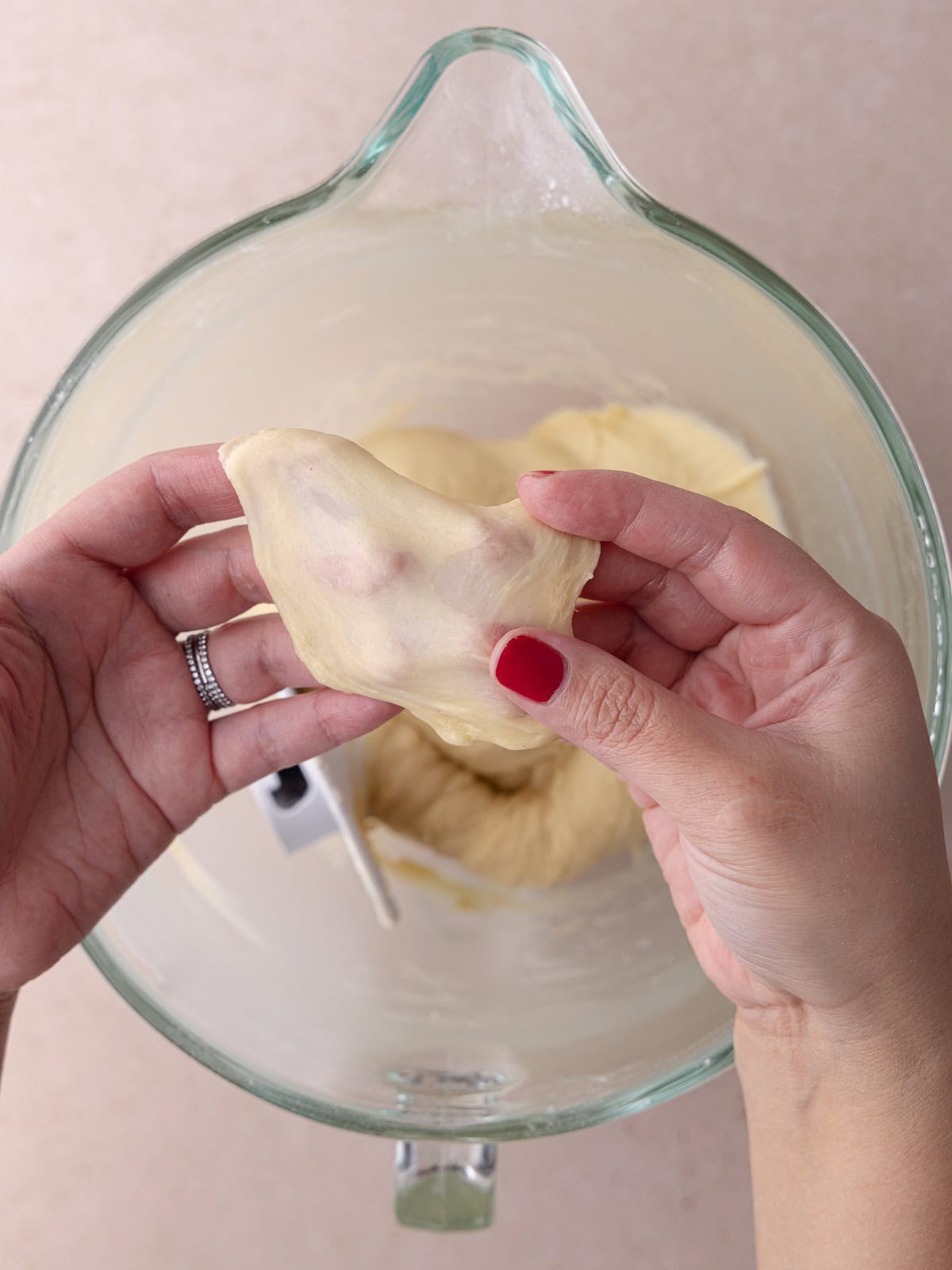 Dough holds a piece of dough and stretches it thin enough to let light through. This is known as the window pane test.