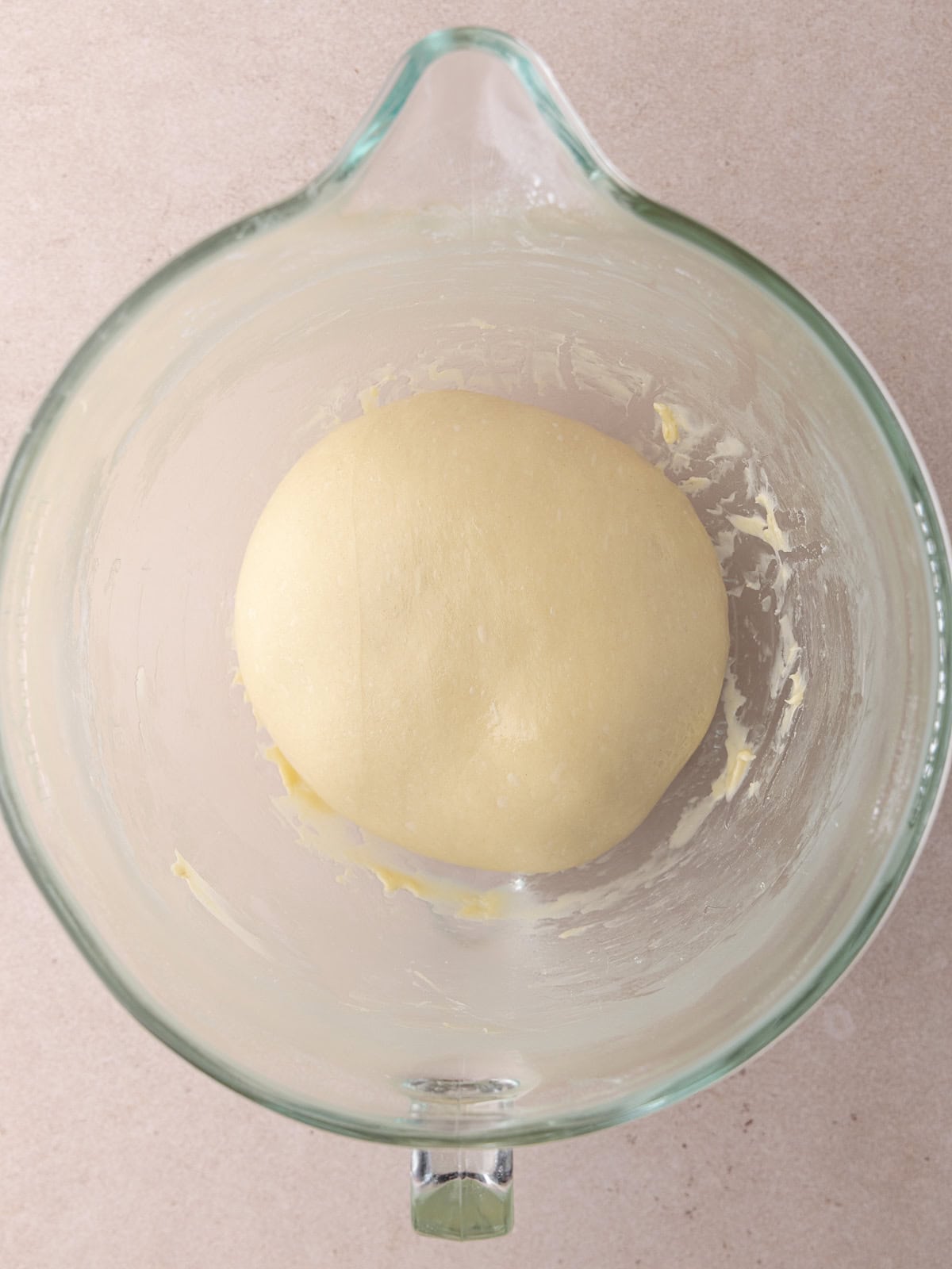 Giant cinnamon roll cake dough in a large mixing bowl.