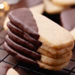 Macadamia nut shortbread also known as, hawaiian shortbread cookies are dipped in chocolate and sitting on a wire rack feature photo.