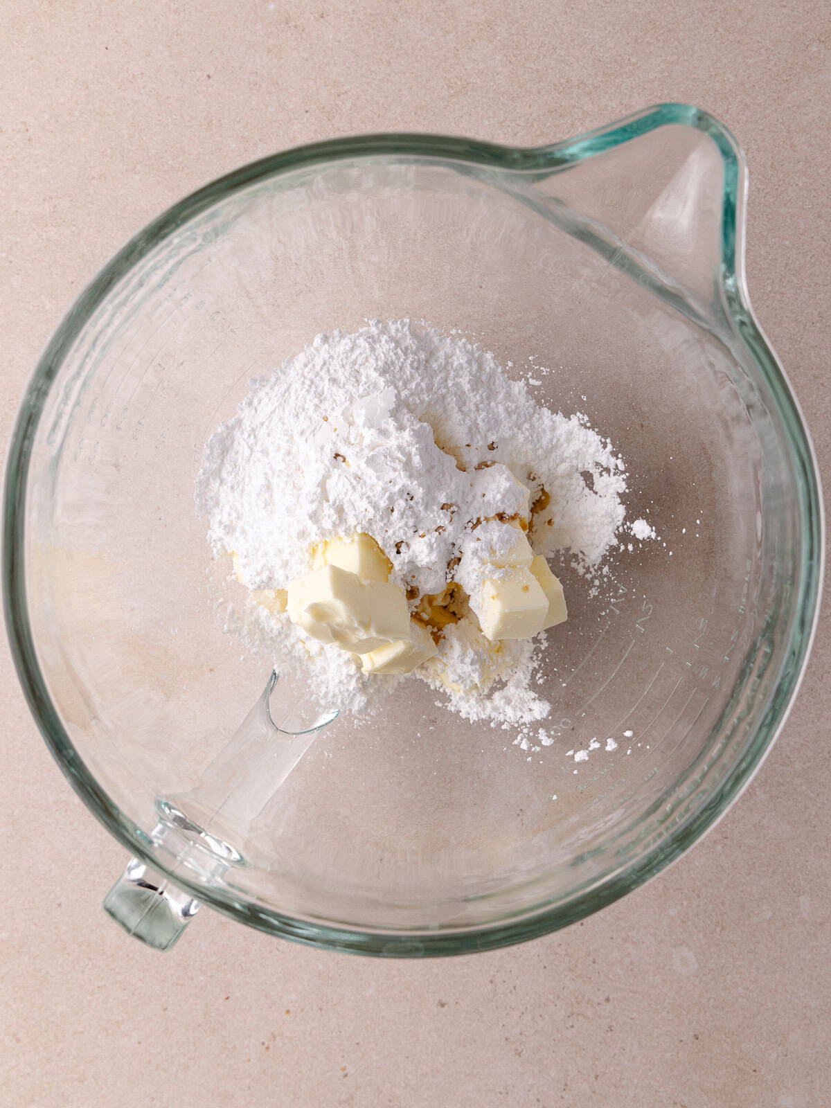 Softened butter, powdered sugar and vanilla are in a large mixing bowl.