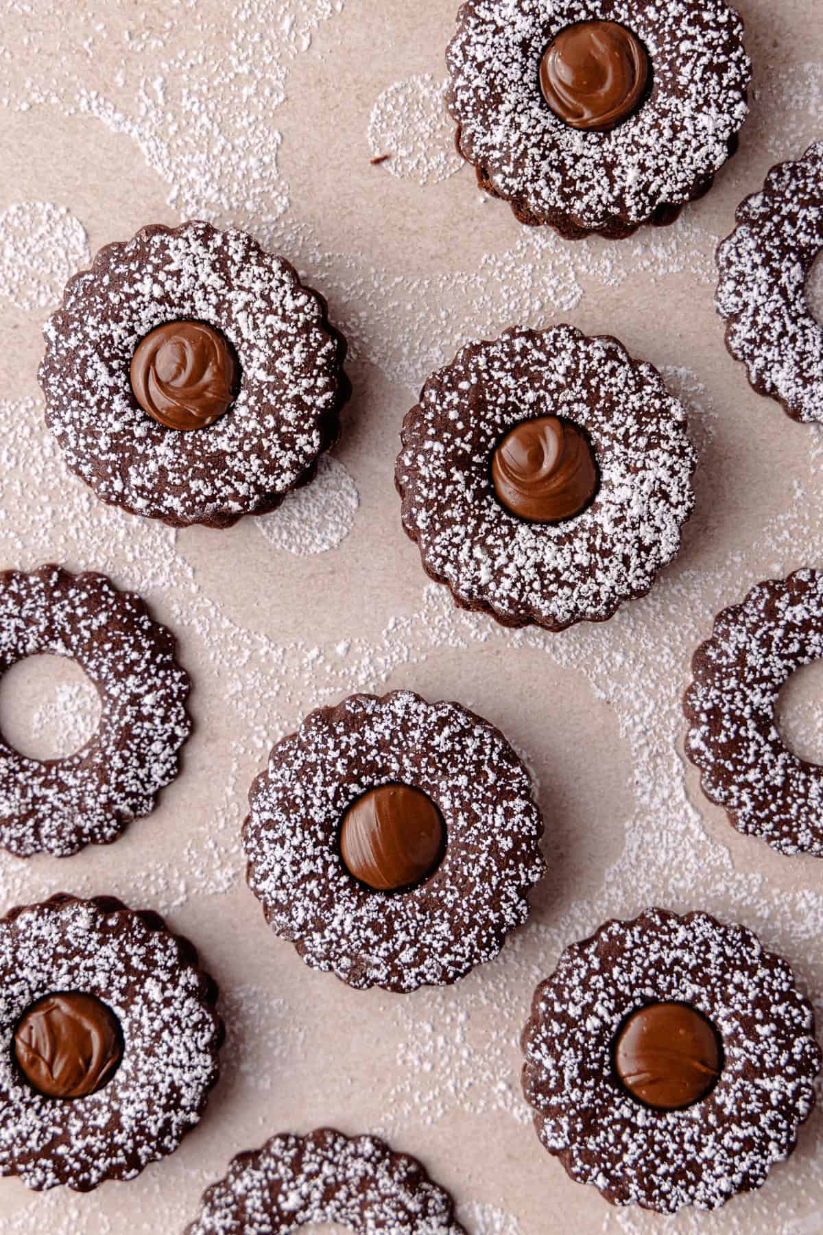 Nutella linzer sandwich cookies are dusted with powdered sugar and filled with Nutella featured photo.