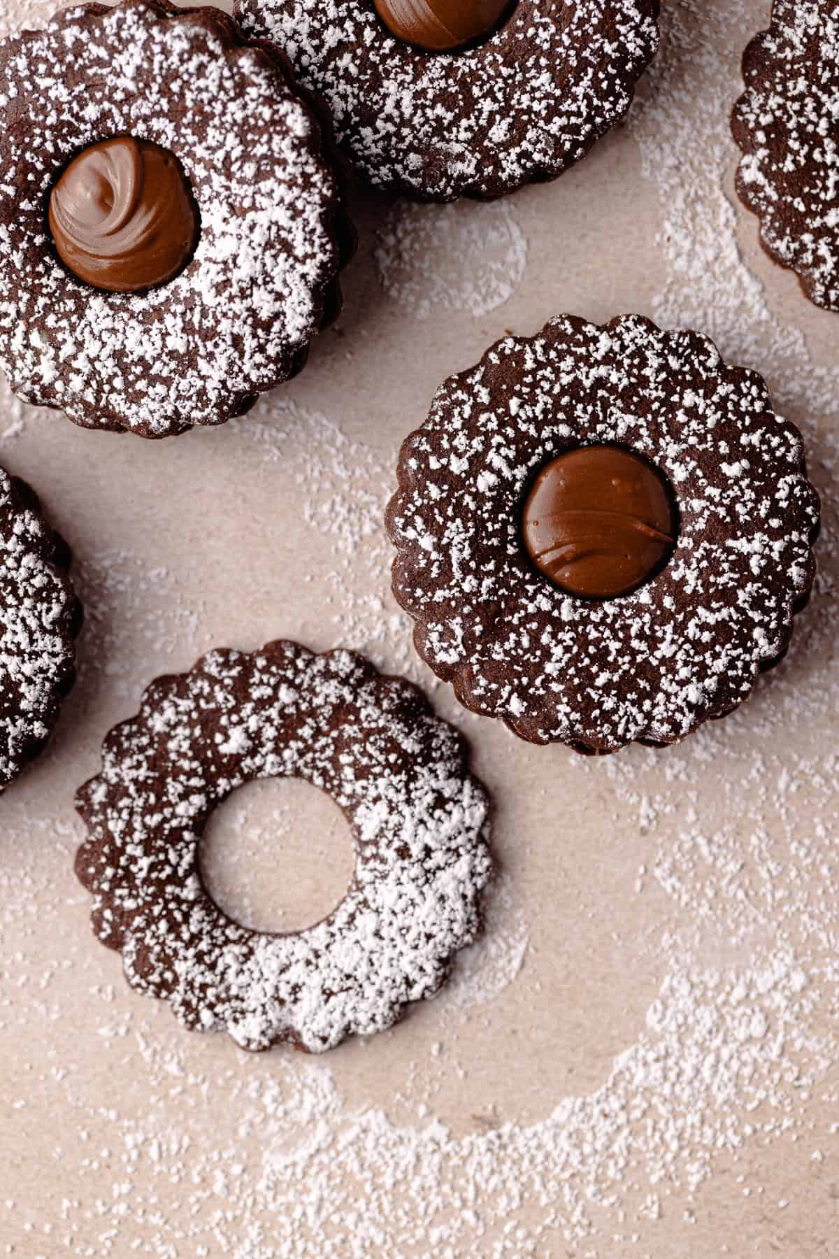 Nutella linzer sandwich cookies are dusted with powdered sugar and filled with Nutella featured photo.