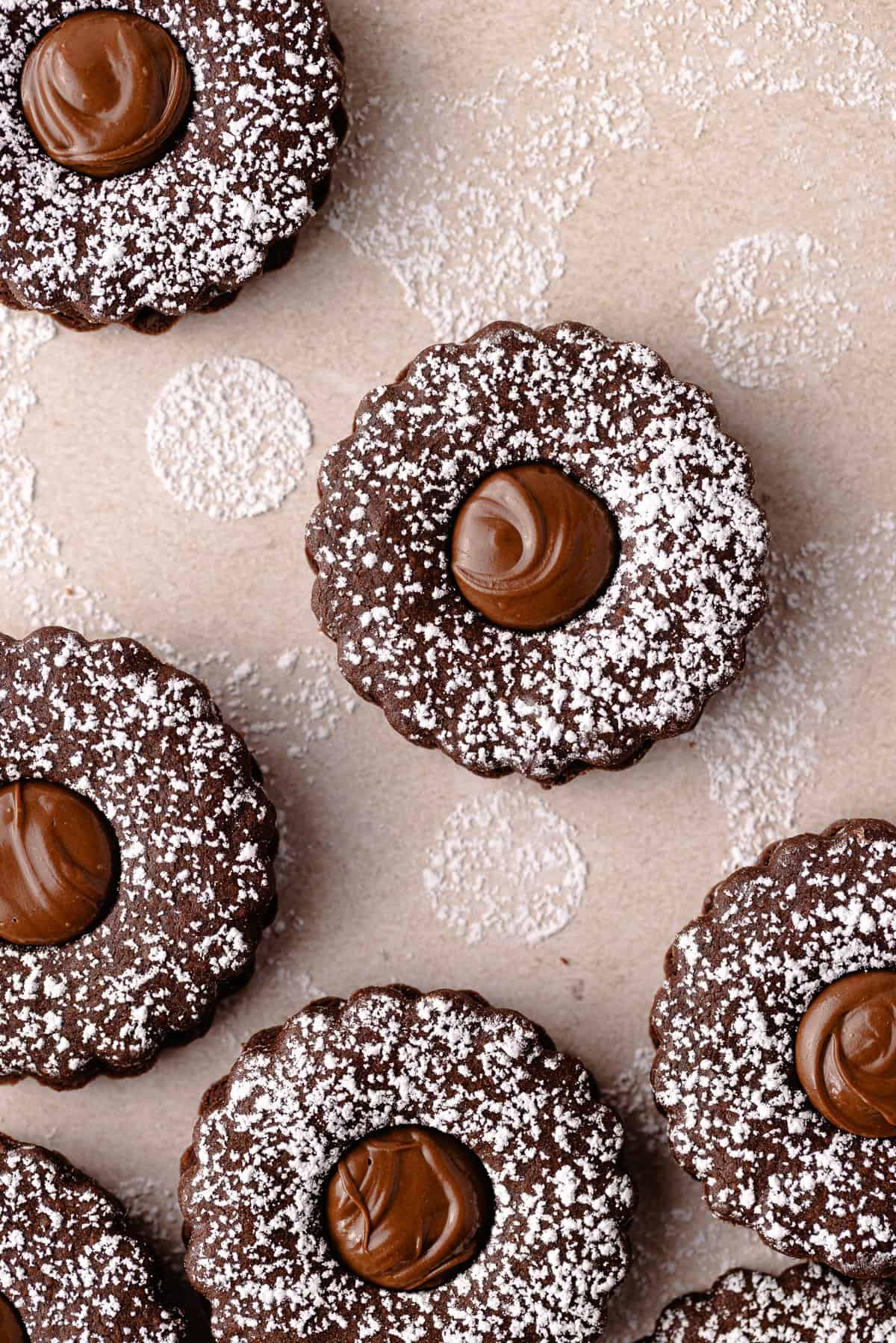 Nutella linzer sandwich cookies are dusted with powdered sugar and filled with Nutella featured photo.