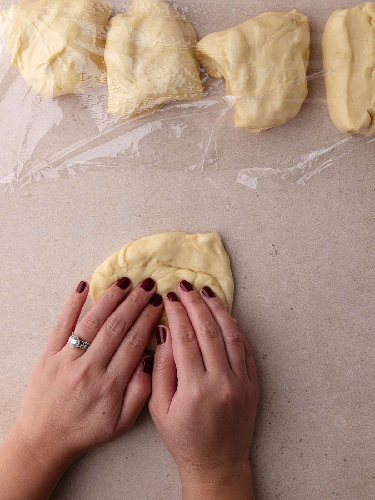 The dough is flattened to release any gas bubbles.