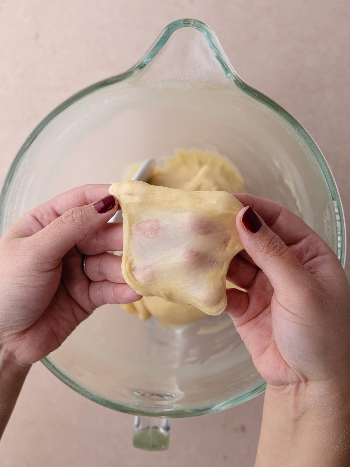 Window pane test is performed by stretching a small ball of dough into a thin square.