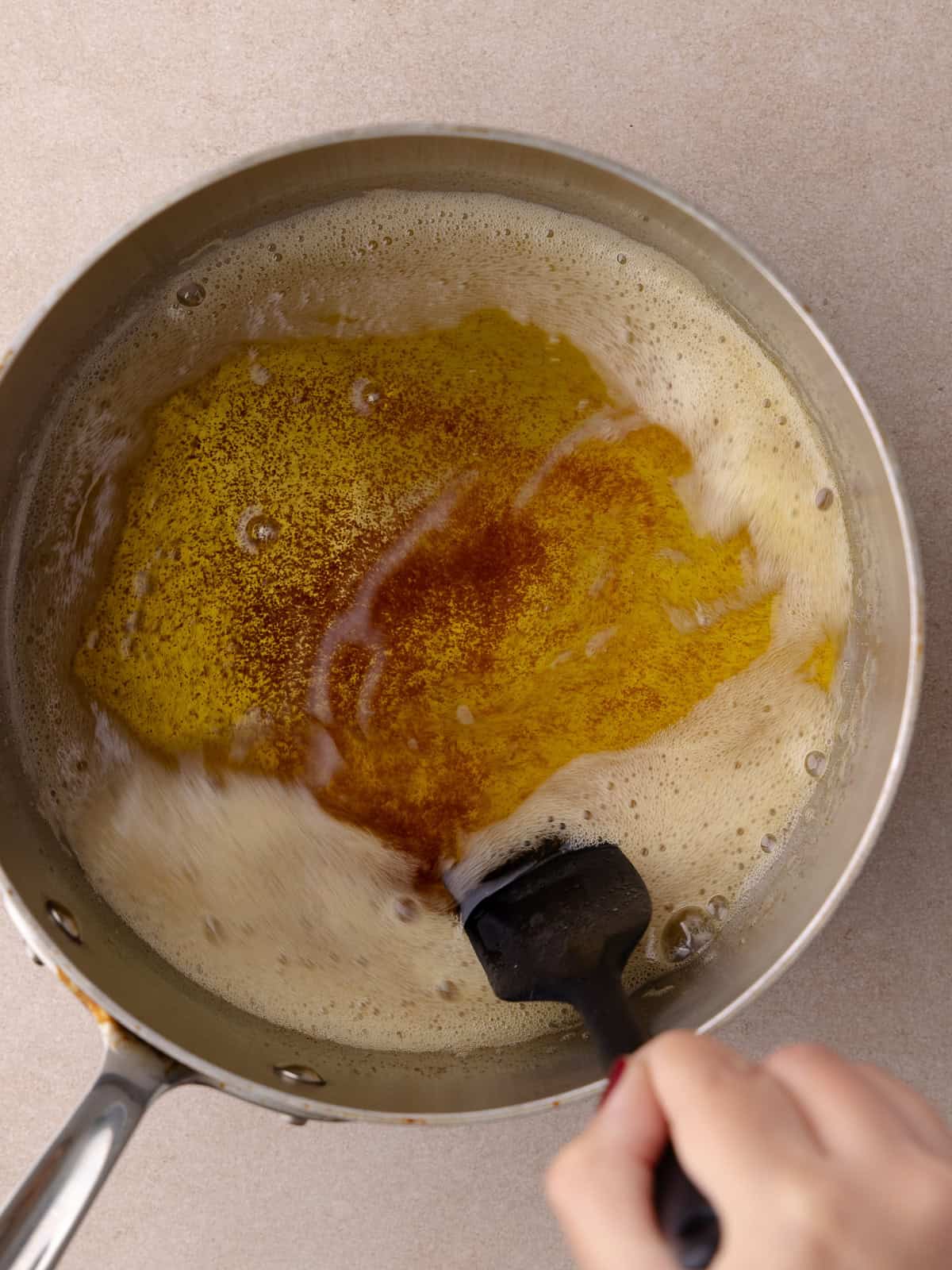 Brown butter is browned in a small saucepan.