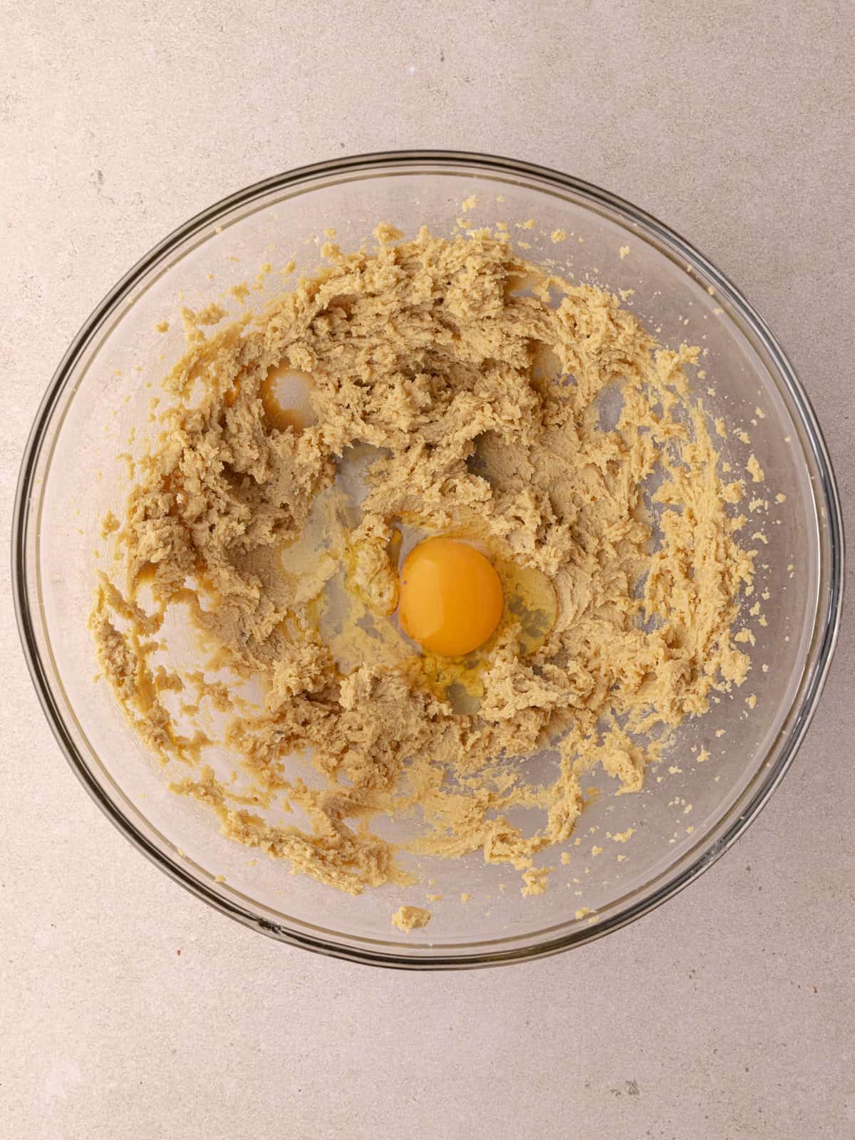 An egg is added to the butter and sugar mixture.