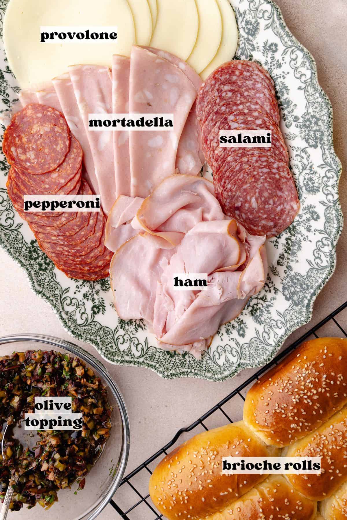 Mini Italian sandwiches ingredients which includes, homemade mini brioche buns, olive topping, provolone cheese, mortadella, black forest ham, pepperoni, and salami.