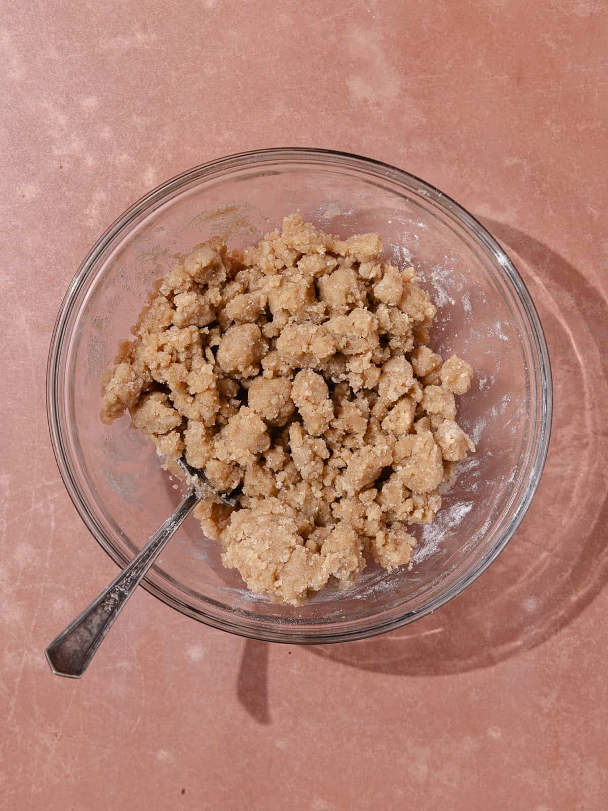 Cinnamon streusel topping is in a small glass bowl.