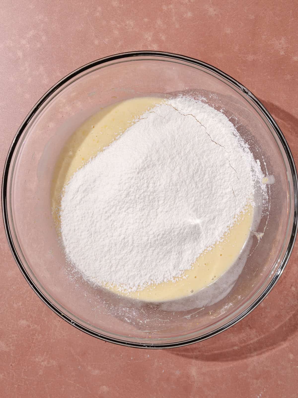 Dry ingredients are sifted in the large glass bowl.