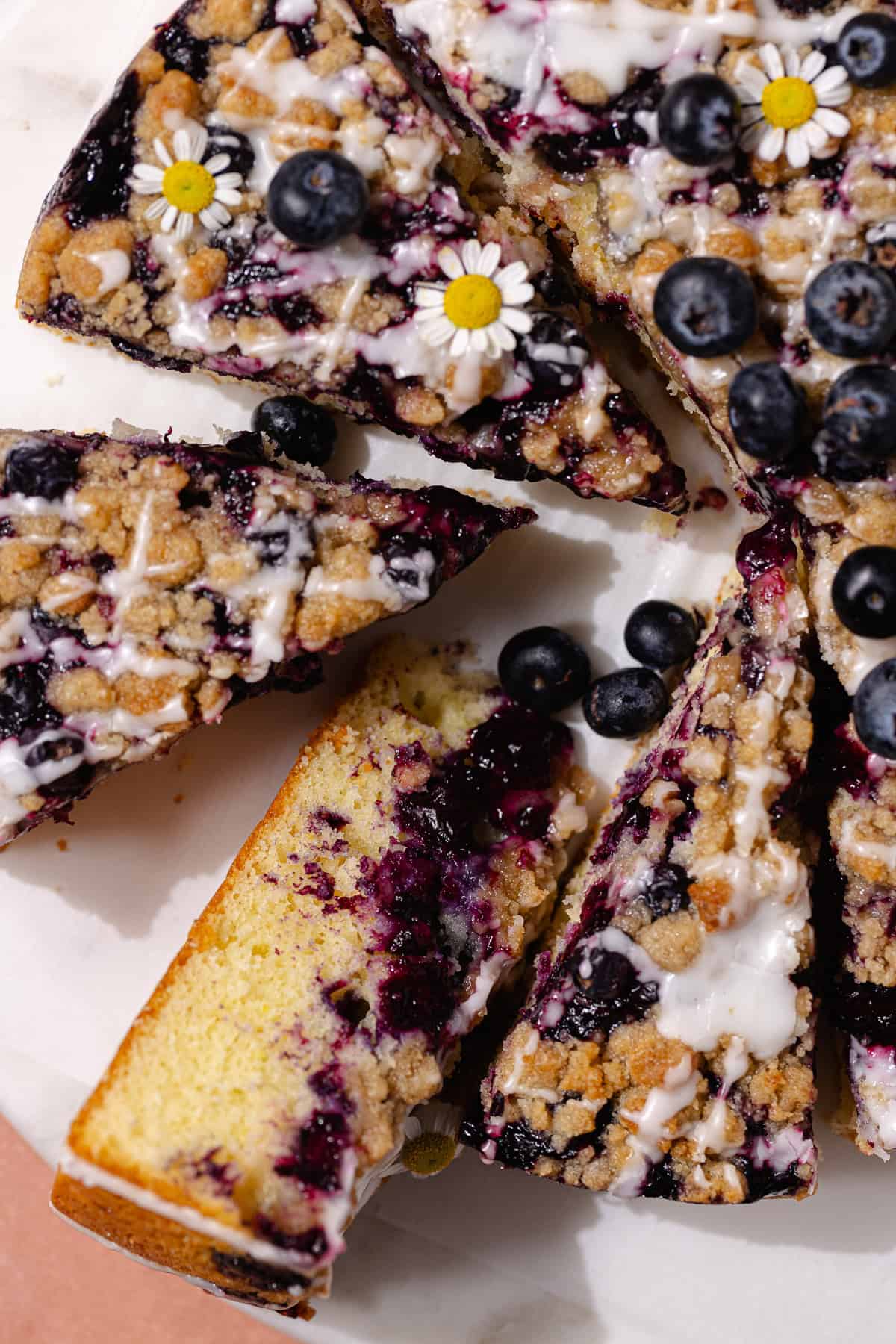 Slices of blueberry lemon crumb cake on a serving platter.