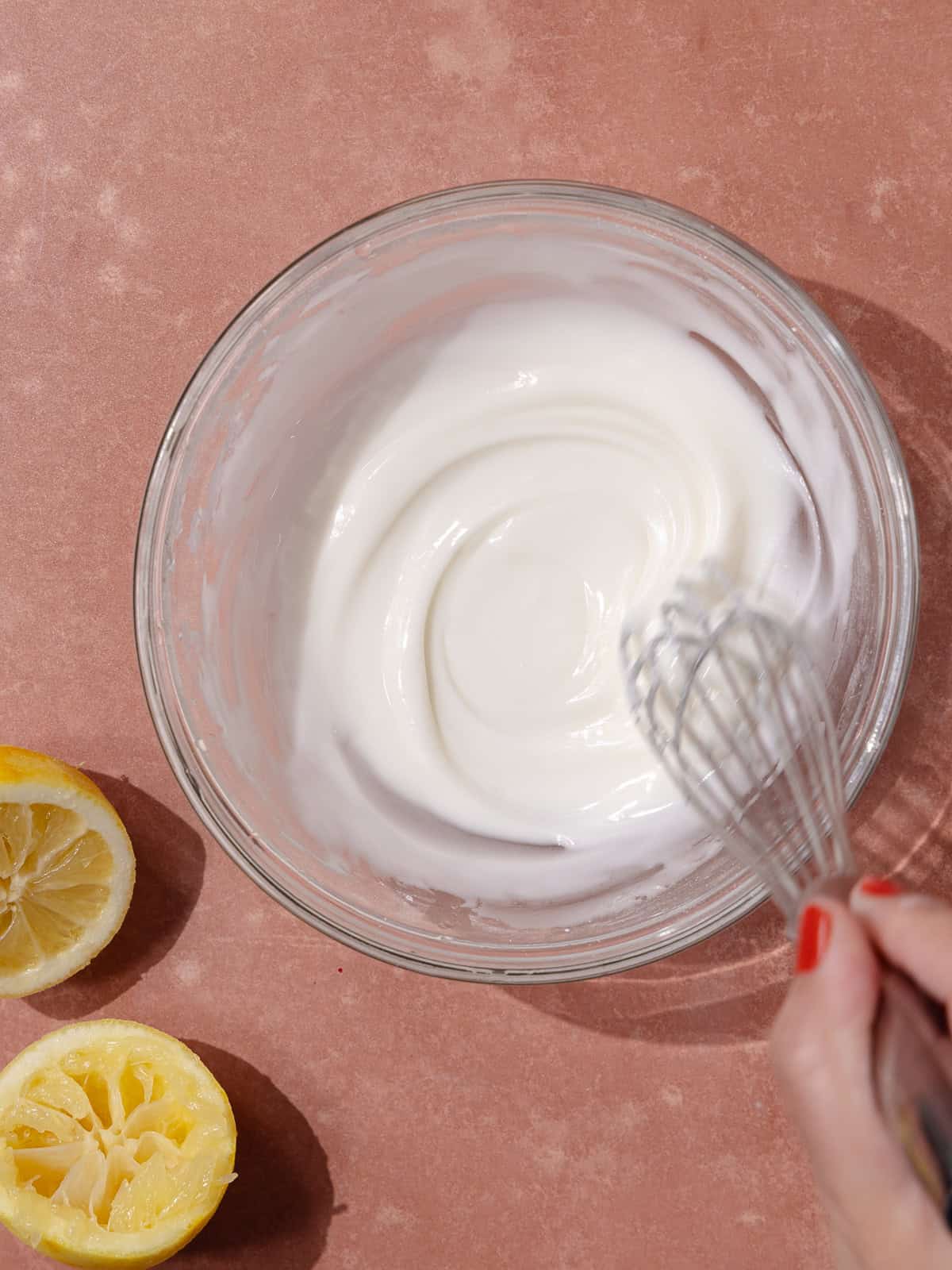 Lemon glaze whisked in a small glass bowl.