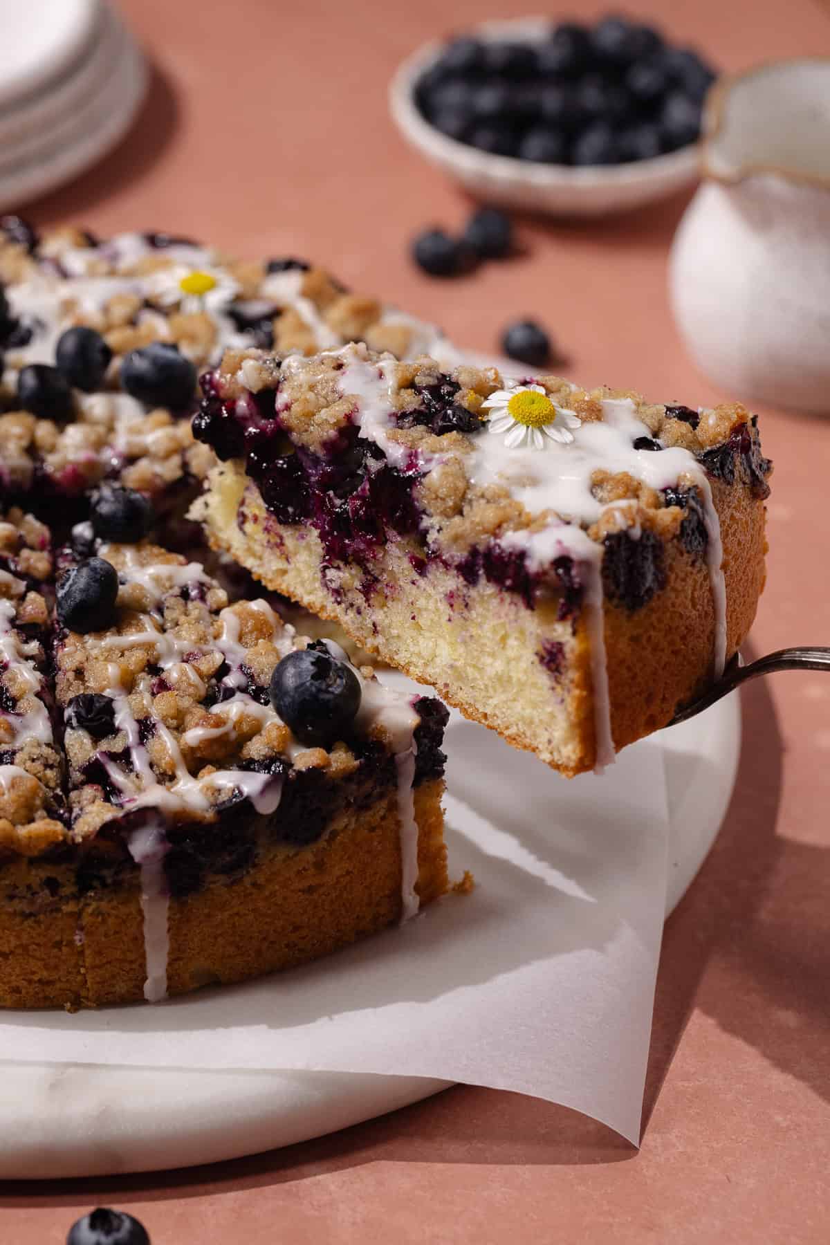 Blueberry lemon crumb cake slice in a cake server.