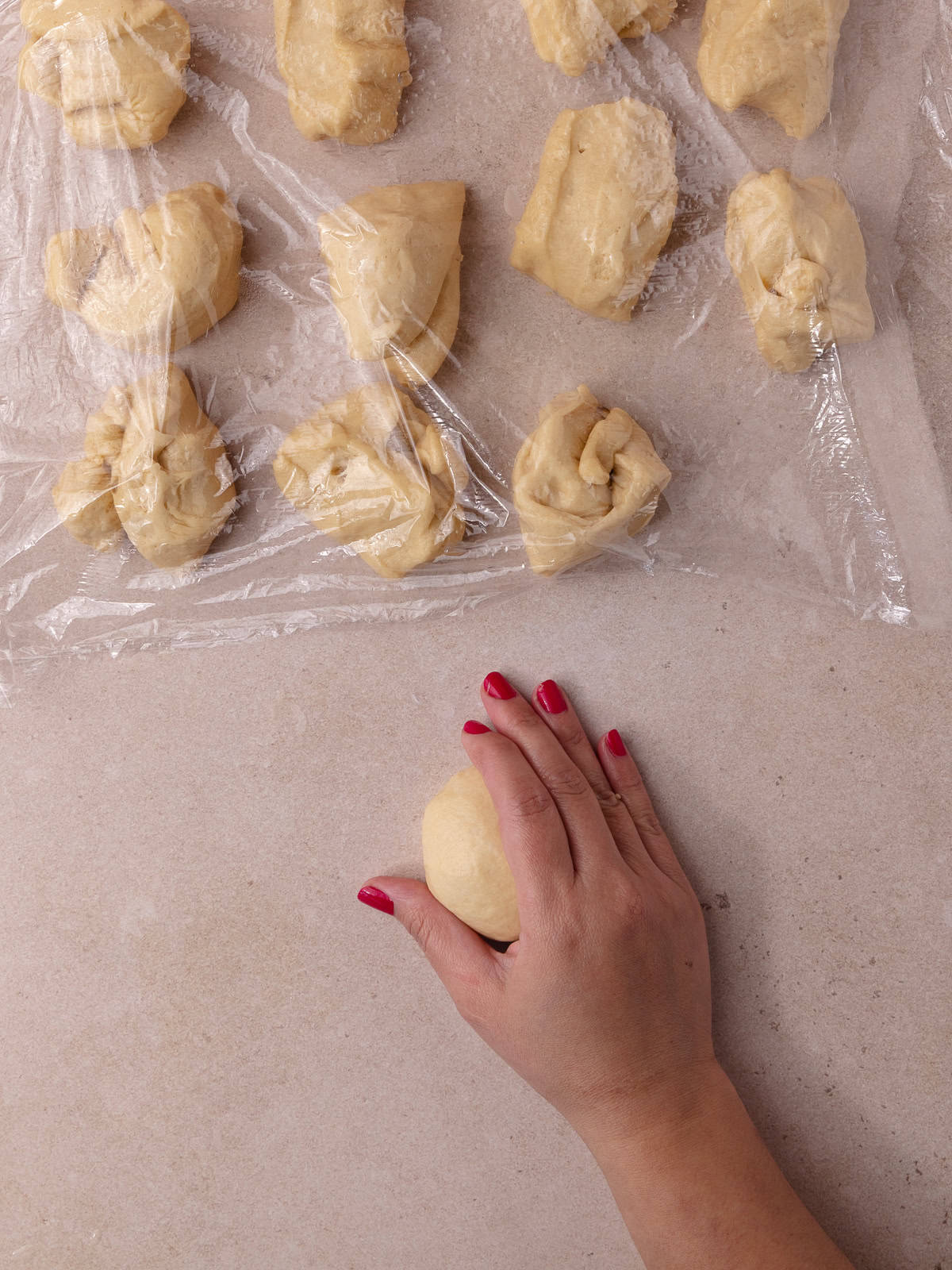 Divided dough is shaped into smooth buns.