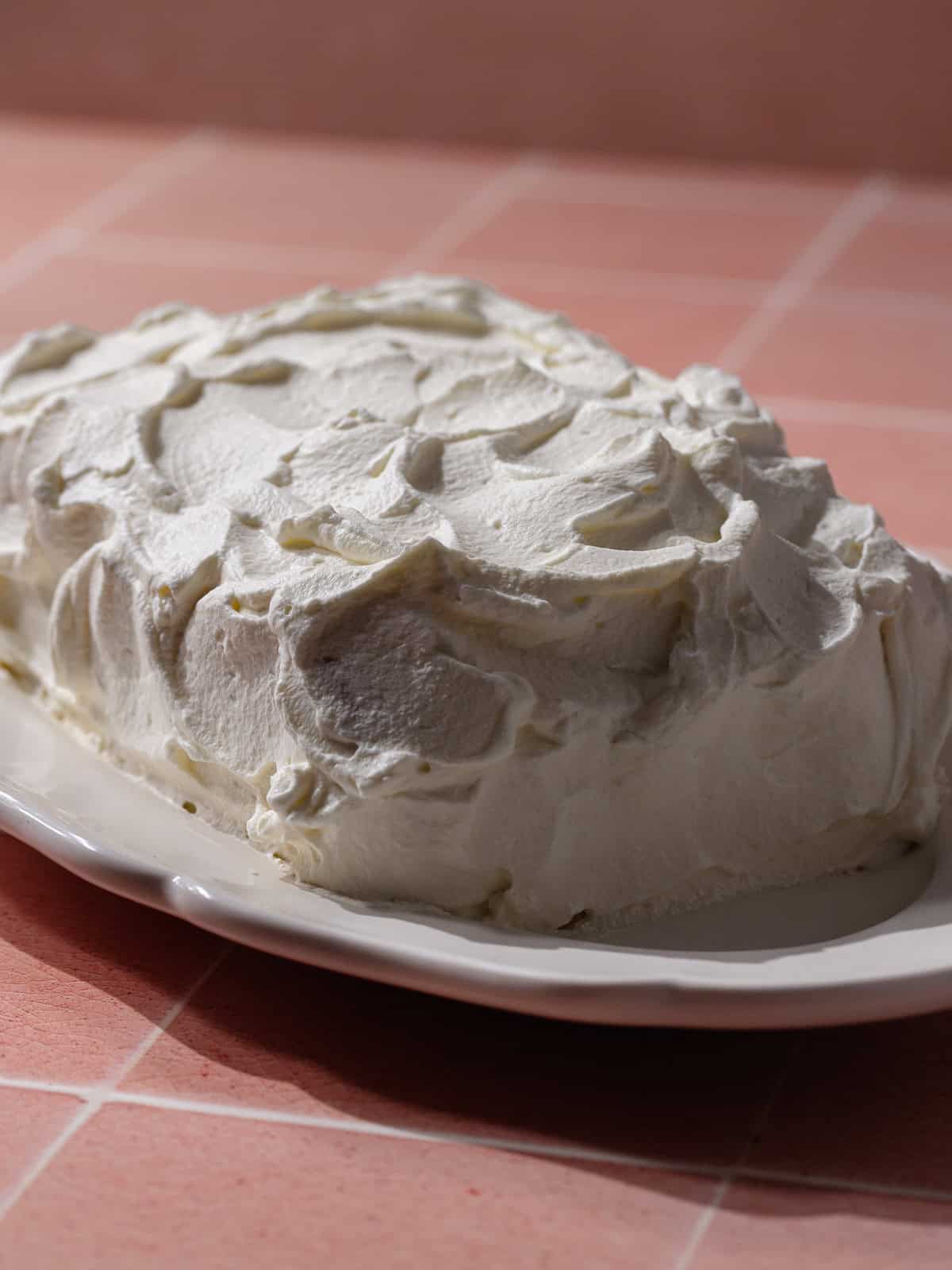 Easy, no-bake strawberry icebox cake covered in whipped cream.