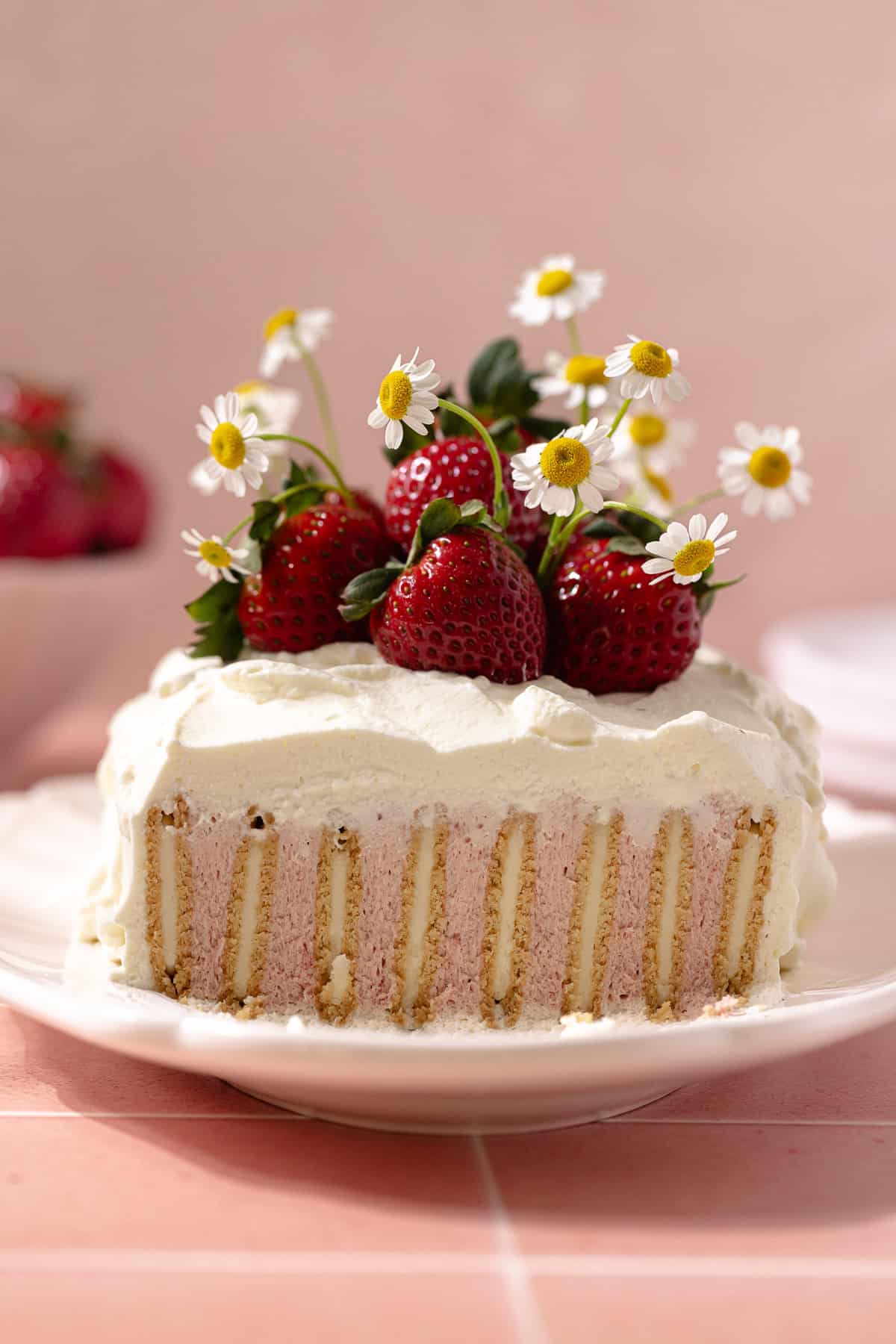 Easy no bake strawberry icebox cake decorated with fresh strawberries.