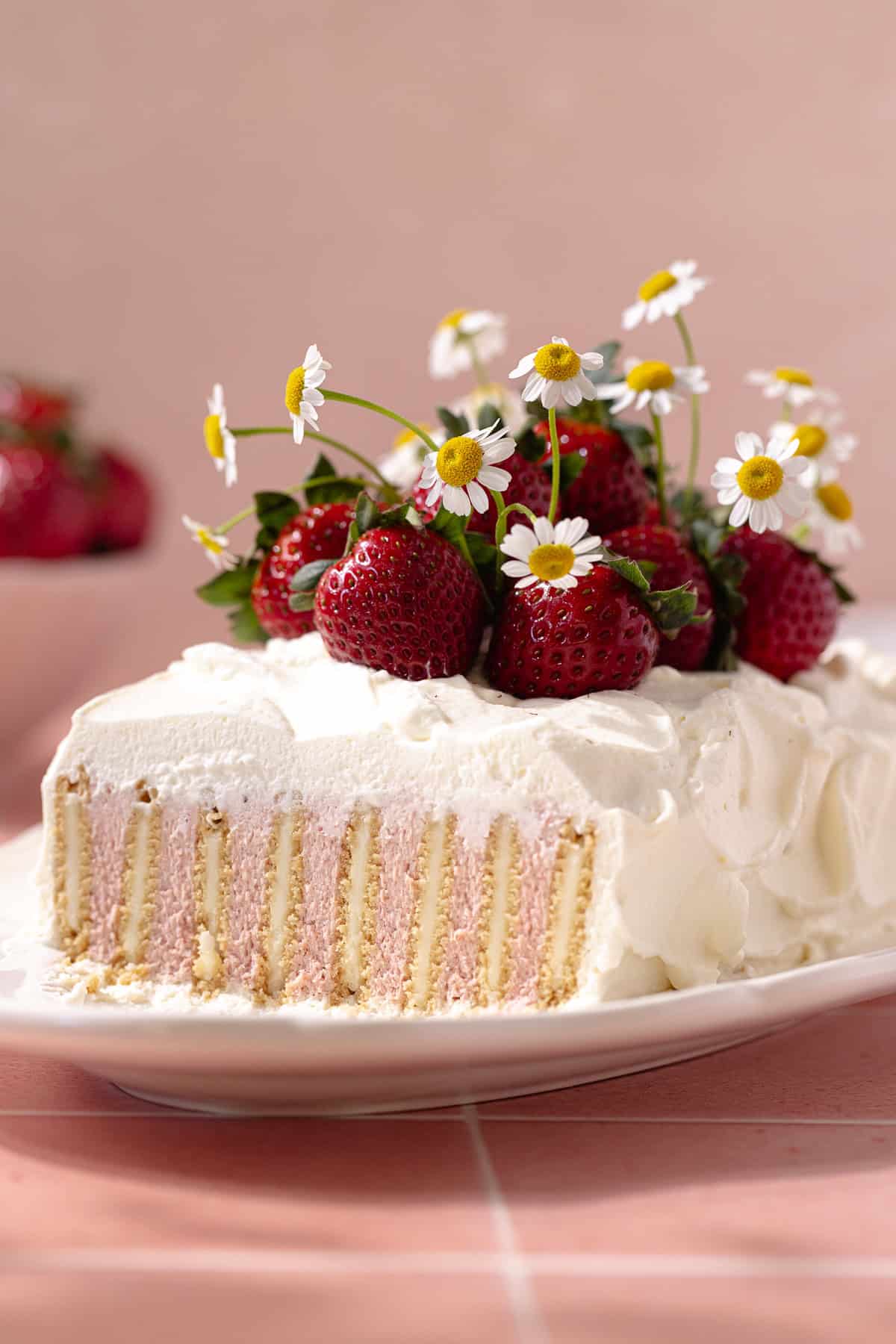 Easy no bake strawberry icebox cake decorated with fresh strawberries.